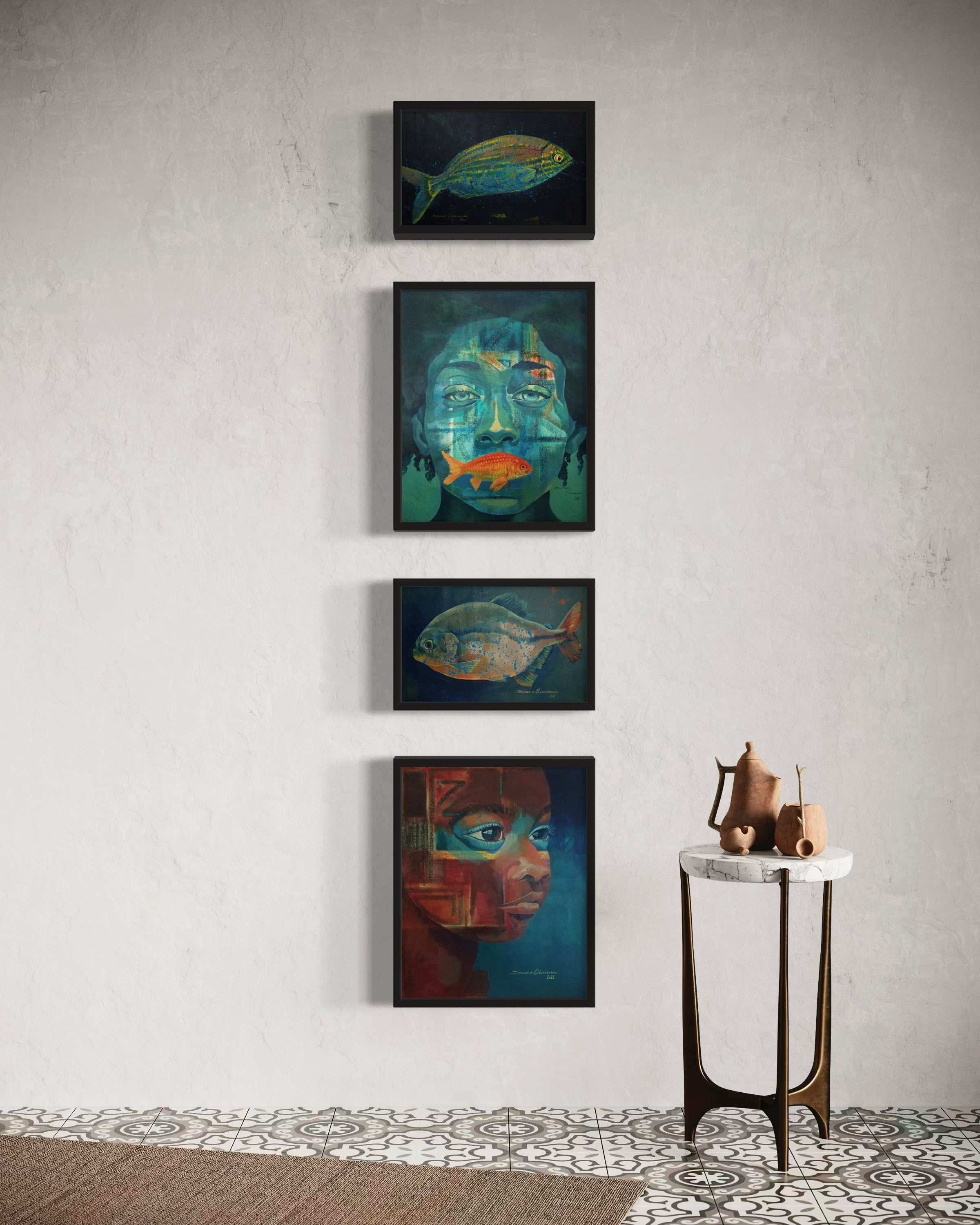 Four framed paintings—two of fish and two of abstract faces—hang vertically on a white wall above patterned floor tiles. A small side table with pottery sits to the right.