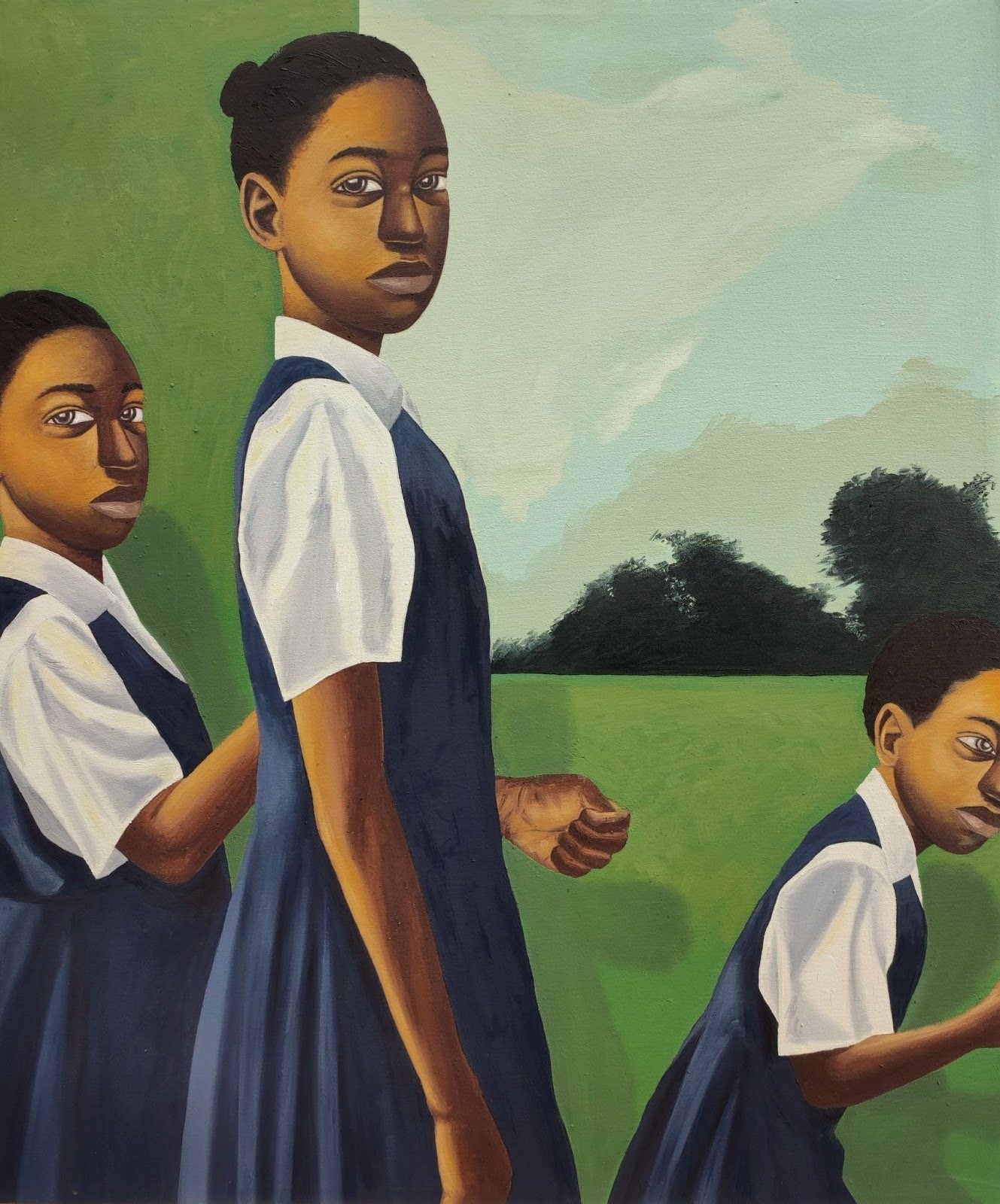 Three girls in blue school uniforms stand outside on green grass with trees and a blue sky in the background. The girls look in different directions, and their expressions are serious.