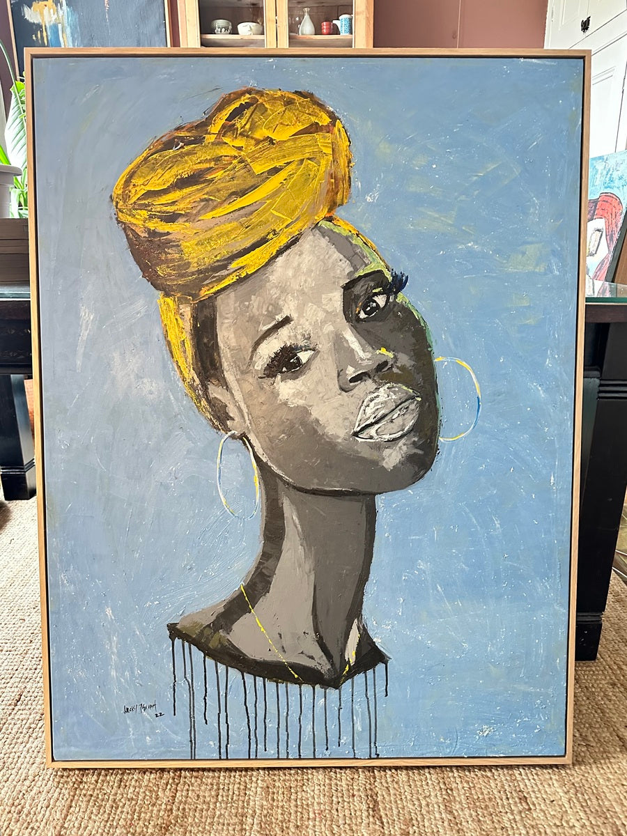 Saffron Gaze" by Lucky Isaiah (119 x 90cm) is a framed portrait of a dark-skinned woman in large gold hoops and a bright yellow headwrap, set against a blue background, reflecting contemporary African art influences.