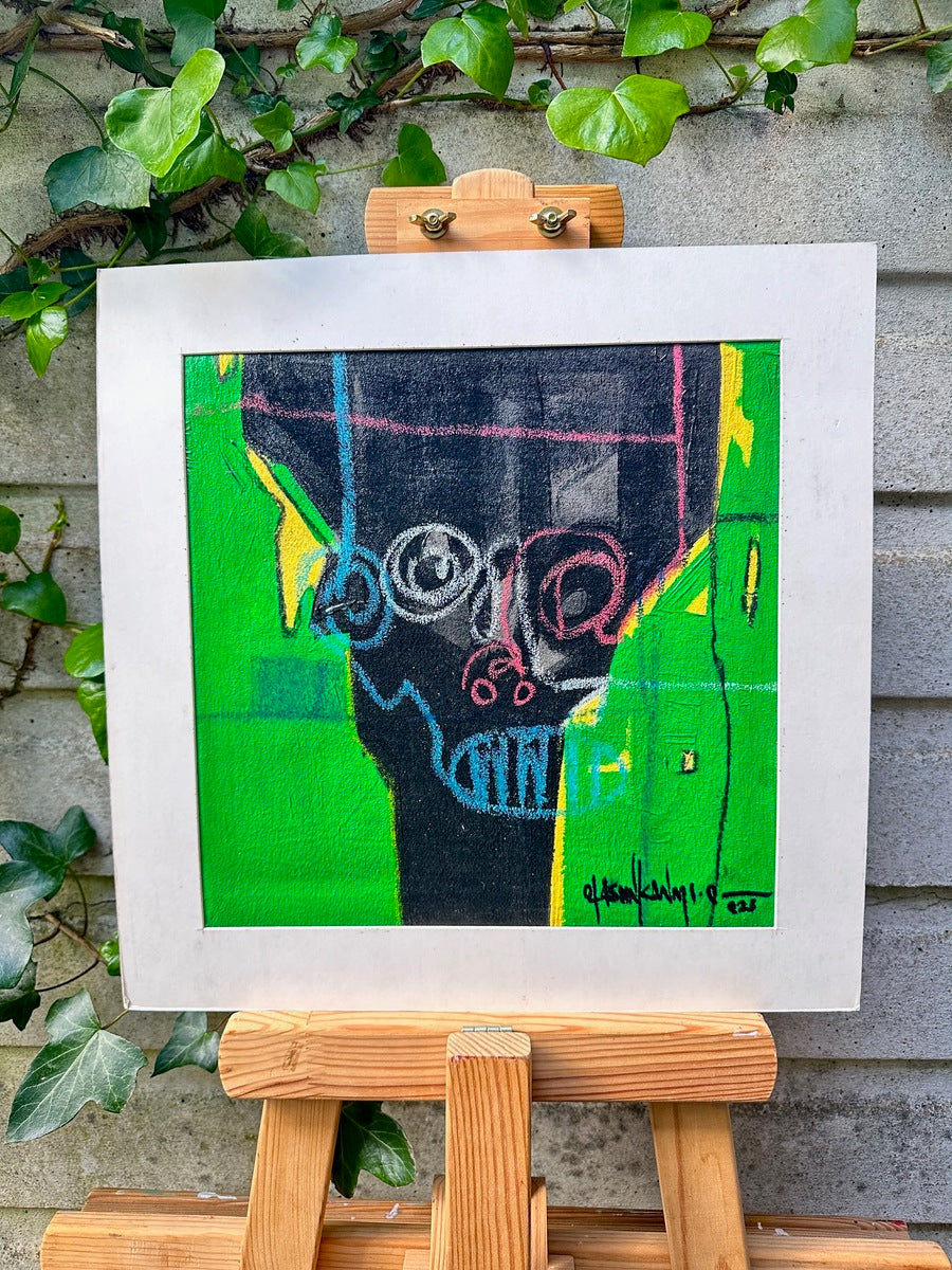 Act 2" by Olasunkanmi Oyelusi: A colorful abstract portrait in green, yellow, pink, and black shapes. Acrylic on canvas, hand-signed, white frame, displayed on easel amid ivy against a gray brick wall. Includes certificate of authenticity.