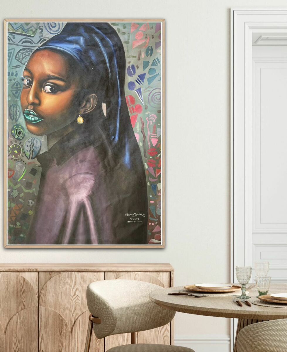 The “My Style” Girl With A Pearl Earring Reimagined by Oluwabukola, a large hand-signed acrylic on canvas of a woman, hangs above a wooden sideboard and overlooks a small dining table set with glassware and plates.