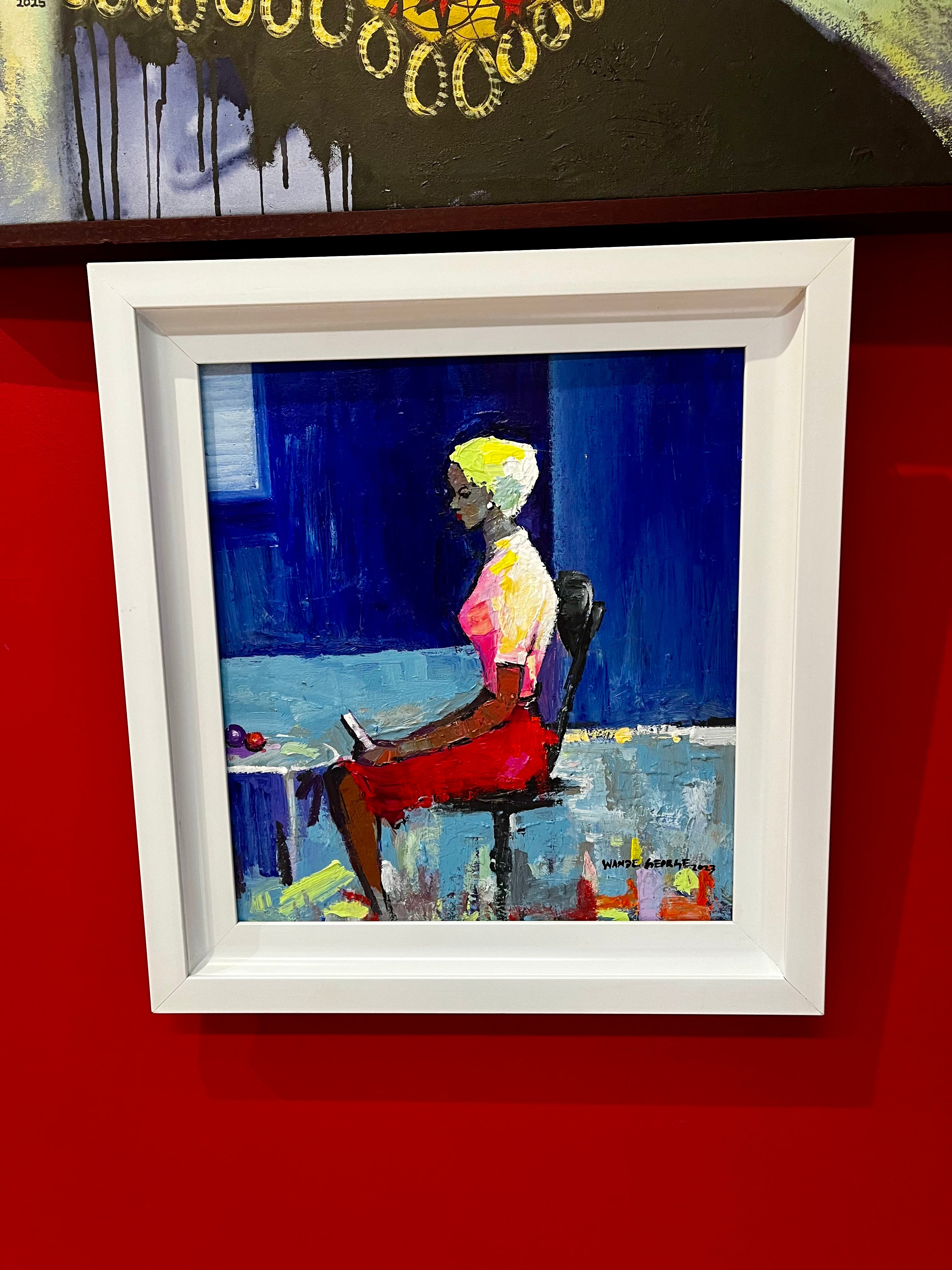Graceful Pose" by Wande George: a framed, hand-signed acrylic on canvas painting of a woman with light hair in a red skirt and white top, seated against a vibrant blue background, displayed on a bright red wall.