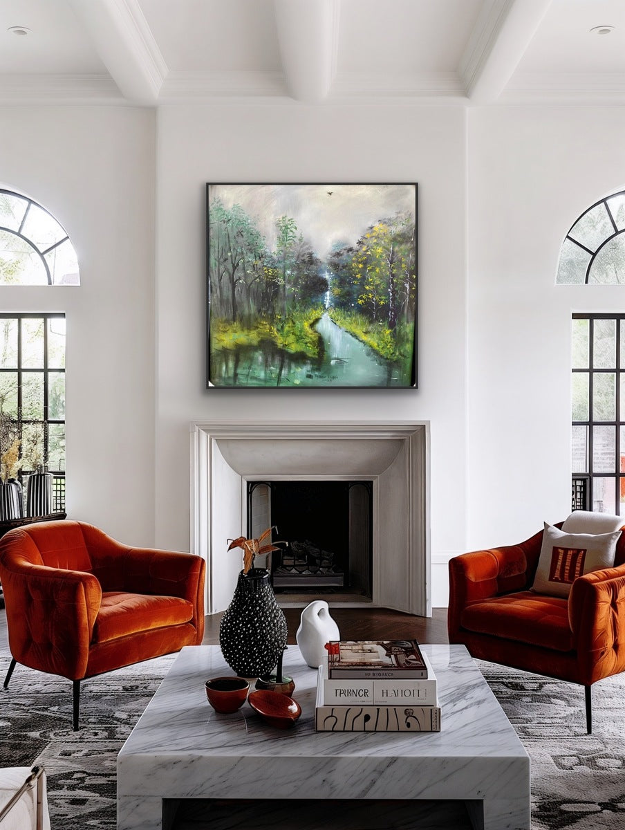 A modern living room with two orange velvet armchairs, a marble coffee table with decor, and a fireplace beneath "The Great Outdoors," an acrylic on canvas forest and river painting by Oyebisi Elijah. Tall arched windows fill the space with natural light.