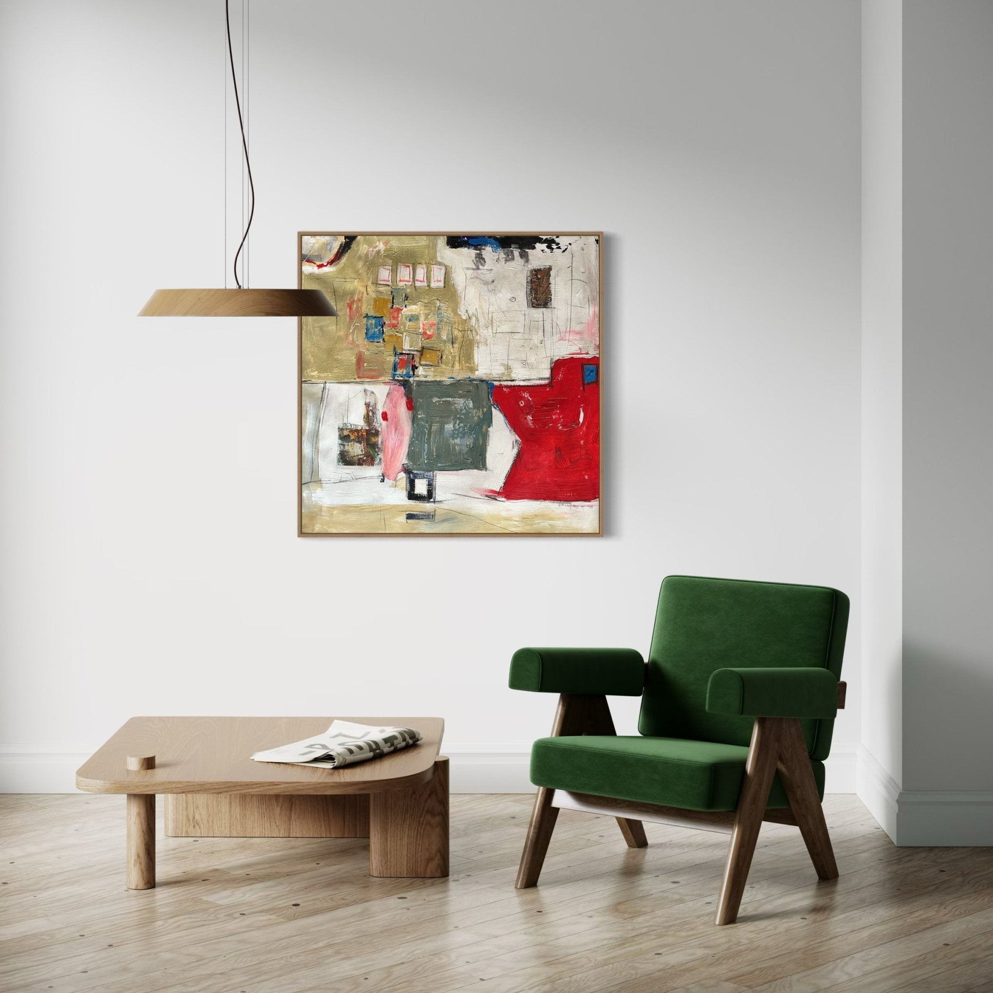 A modern, minimalist room features a green armchair, wooden coffee table, and "Urban Tapestry" by Kehinde Badmuss—a contemporary African artwork—on a white wall. A wooden pendant light hangs above the table on a light wood floor.