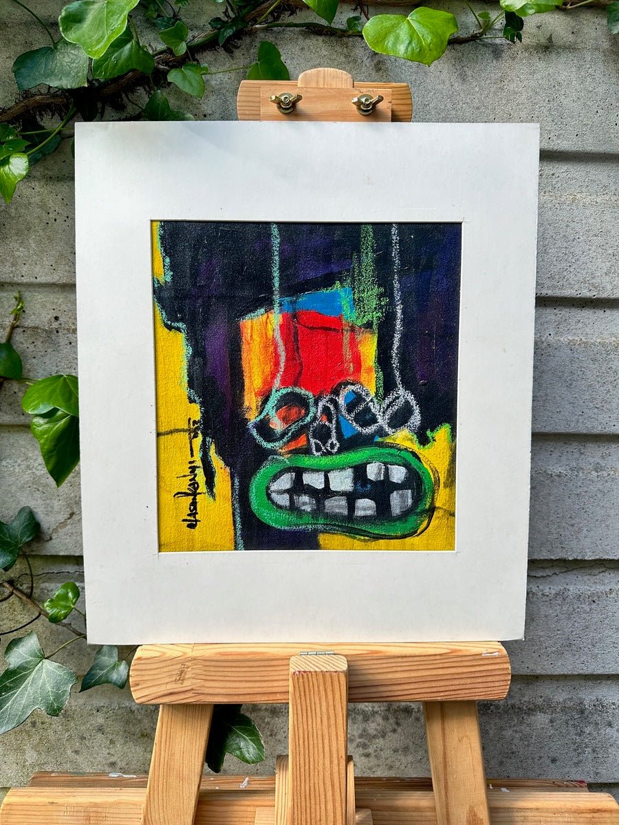 Act 3" by Olasunkanmi Oyelusi is a vibrant acrylic abstract on canvas, featuring a face with large green lips, white teeth, and eye shapes. Displayed on an easel with ivy and concrete wall behind. Hand-signed and includes certificate of authenticity.