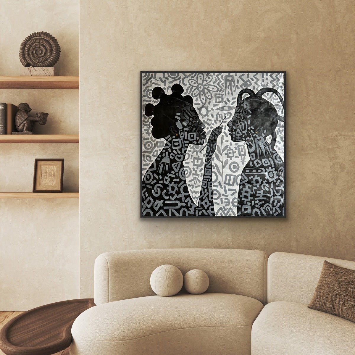 A modern living room with a beige curved sofa and shelves, featuring Afuope Opeyemi's Monochrome Large Acrylic Painting on Canvas, "Adornment," a framed, hand-signed African artwork displayed above.