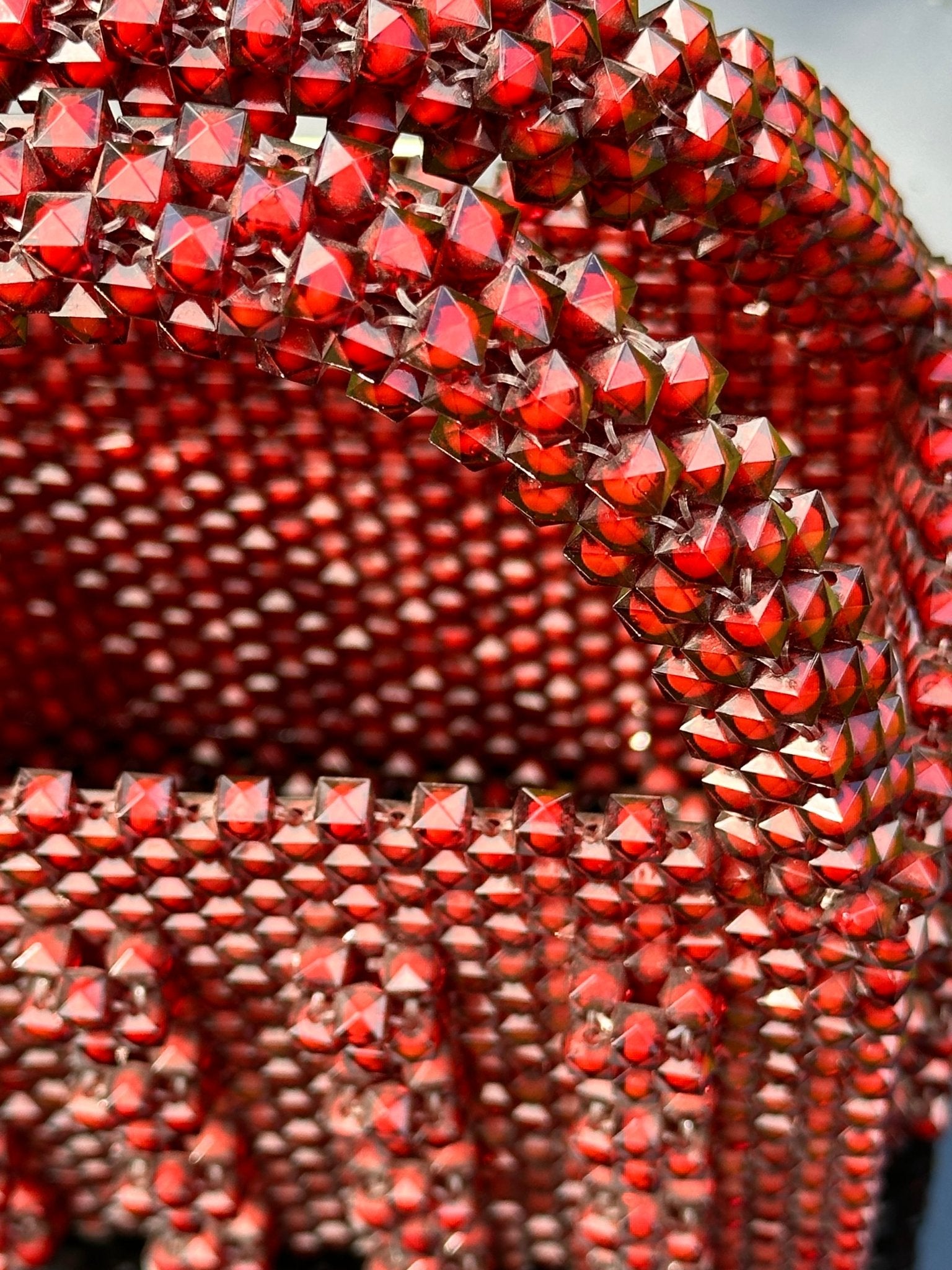 Close-up of the Ariaba Ira Box Bag in burgundy from bibianna.co.uk, featuring a structured silhouette adorned with shiny square gemstones and a matching beaded handle.