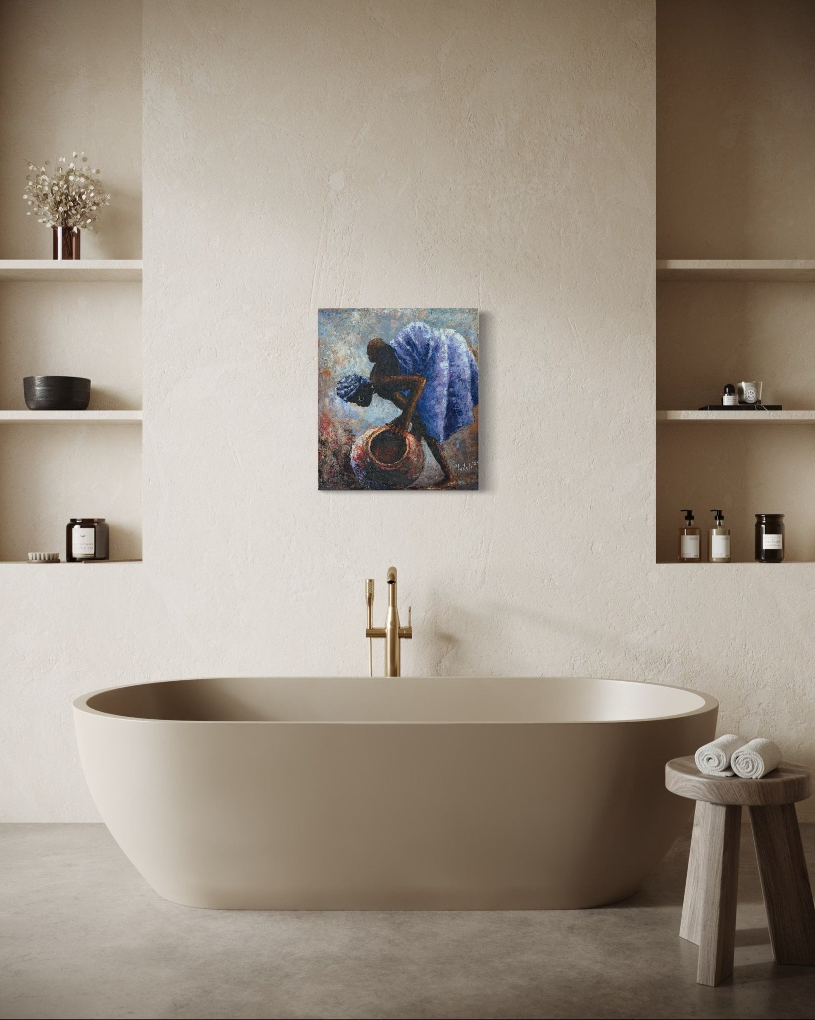 A modern bathroom with a beige freestanding tub, shelves with decor and bottles, a wooden stool with rolled towels, and "Backed Up" by Sunday Oladele, an original Nigerian art painting of a woman, displayed above the tub.