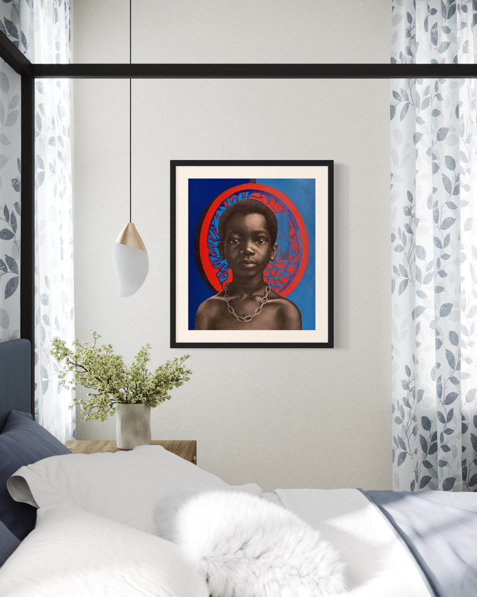 Chain Of Trauma II" by Taiwo John Afuye is a framed, hand-signed acrylic portrait of a young Black boy with a chain necklace, displayed above a bed in an airy room with stylish decor and a potted plant on the bedside table.