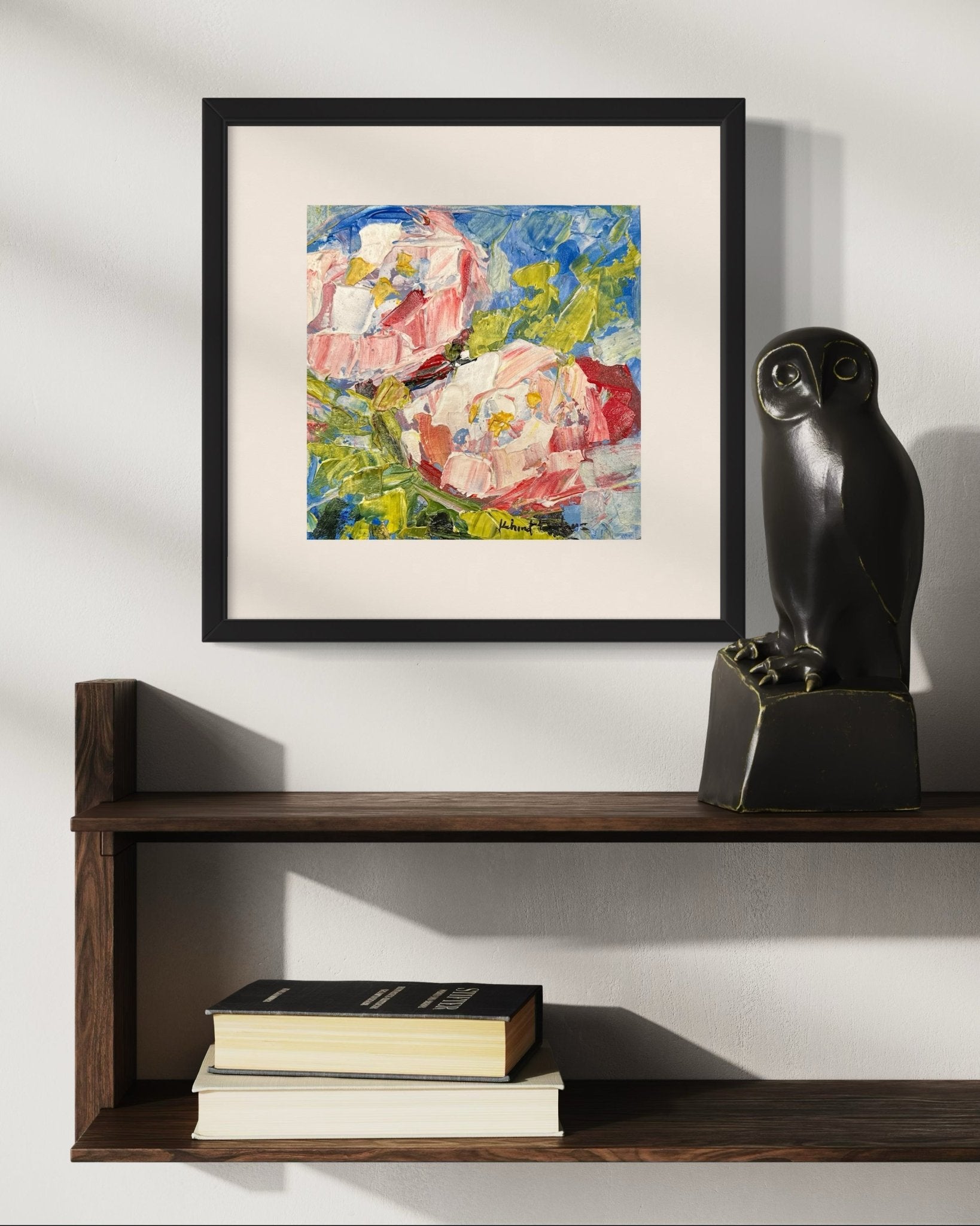 A Contemporary Textured Abstract Floral Miniature Painting by Kehinde Badmuss hangs above a dark wooden shelf with a black owl sculpture and books, set against a white wall with soft shadows.