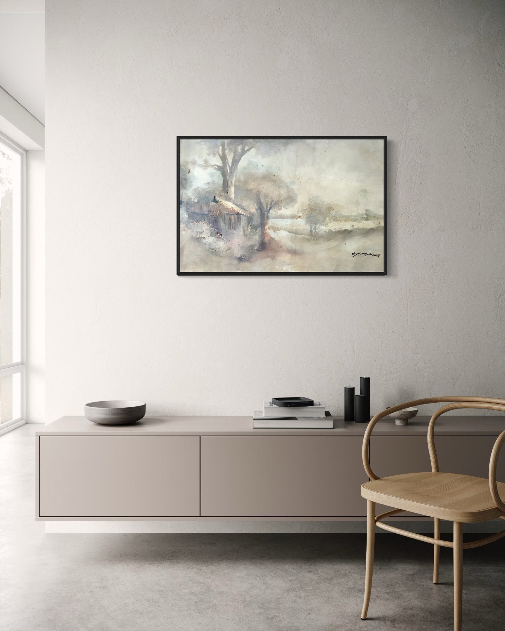 A minimalist room with neutral tones features a wooden chair, a light sideboard, and "Elegant Pastel Classic Landscape Painting" by Doyin Bayo—framed and hand-signed—on the wall. Soft light enters through large windows on the left.