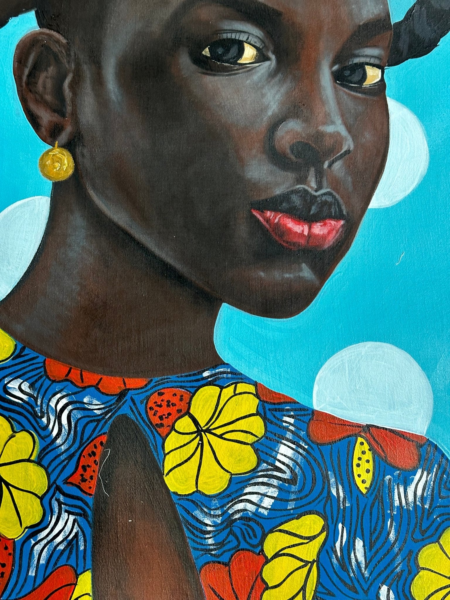 Enigmatic Beauty: 'Lady' by Ajenifuja Abiodun—a close-up portrait of a dark-skinned African woman with red lips, gold earrings, and a floral patterned top set against a bright blue background with white circles.