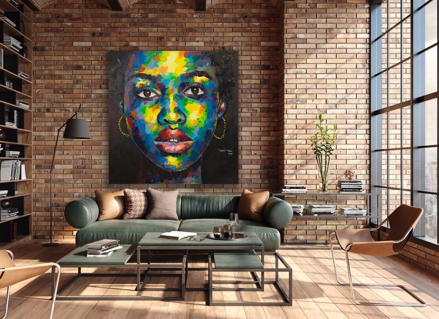 A modern living room with brick walls and large windows showcases "Feels like me," an extra large original painting by Agboola Emmanuel I, displayed above a green sofa amid stylish furniture and decorative shelves with books and plants.