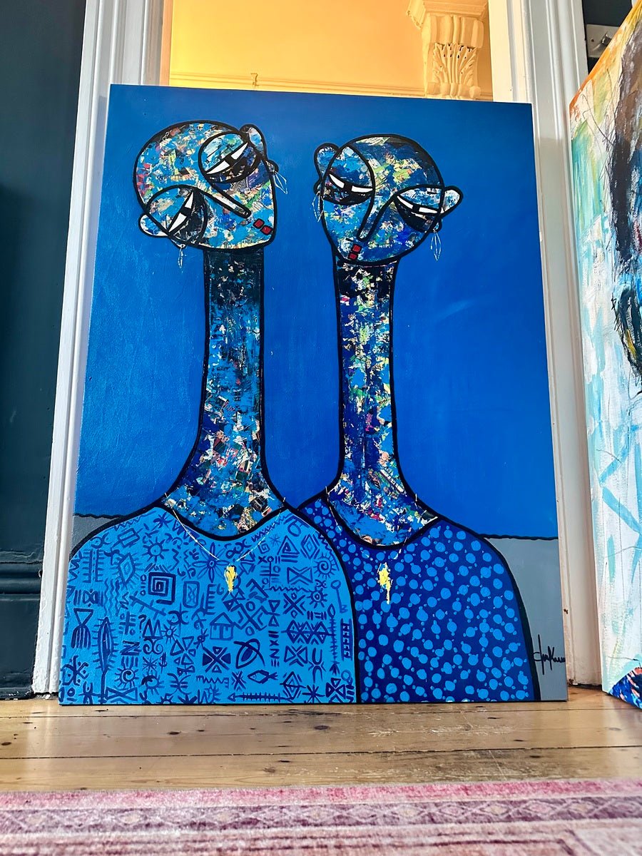 Friendship" by Chukwuma C is a mixed media acrylic and paper painting depicting two abstract blue figures with elongated necks, patterned clothing, and colorful textured accents, leaning against a doorway on a wooden floor.