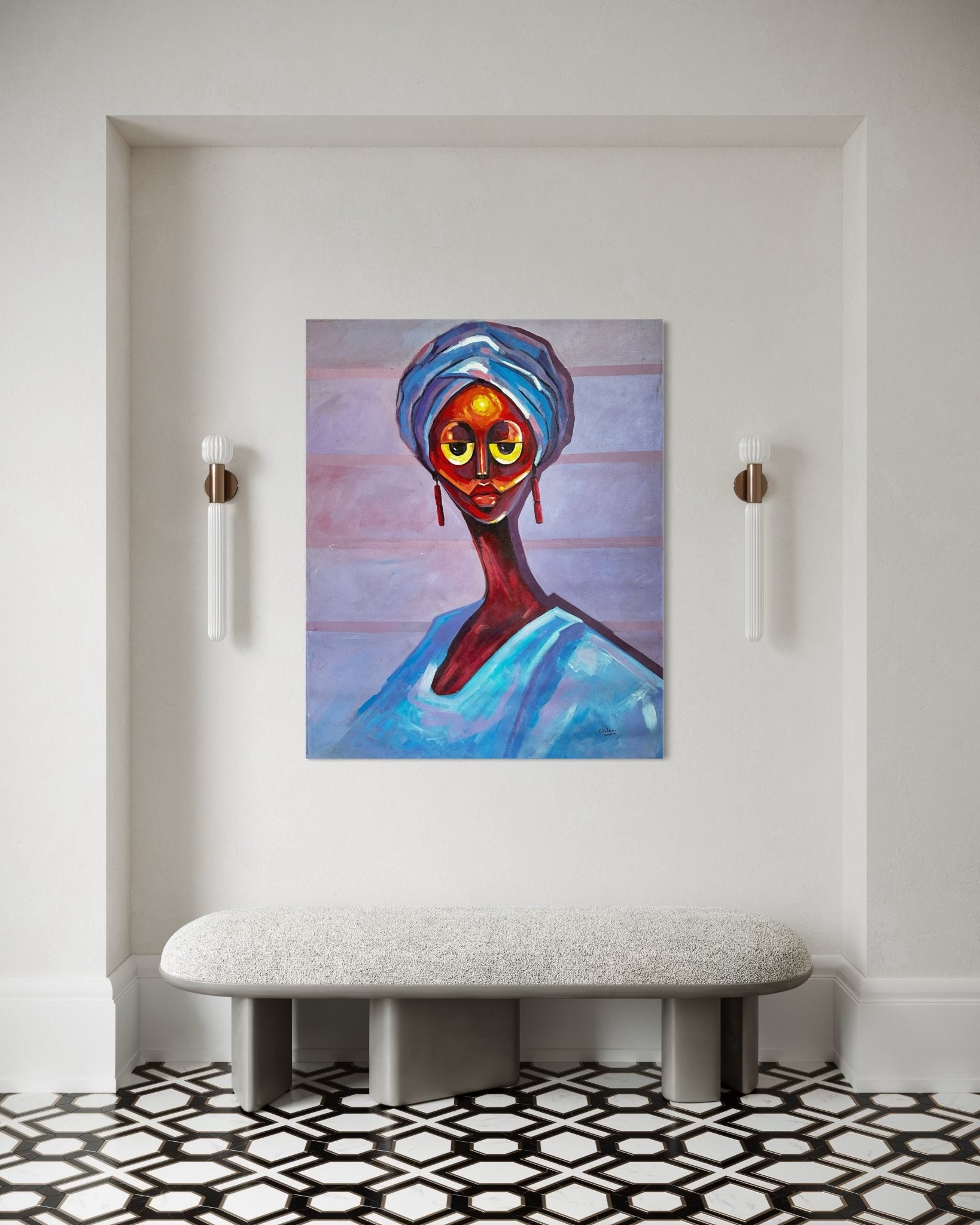Gele Queen" by Bibianna African Art Collective—a vibrant portrait of a woman in blue—accentuates a light wall above a cushioned bench, with modern sconces and a black-and-white geometric tiled floor completing the space.