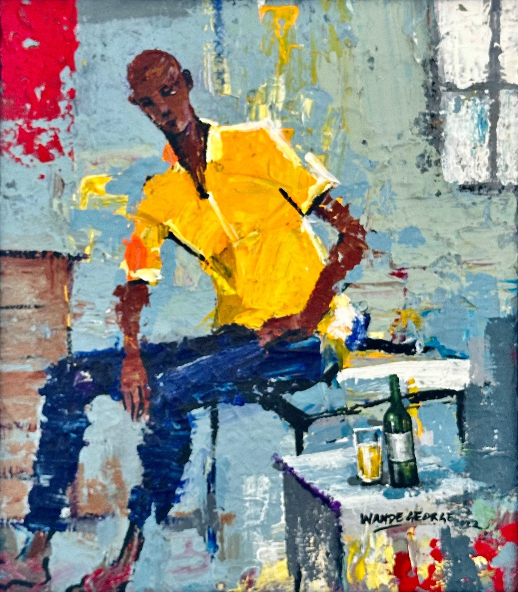 'Good Company' by Wande George is an abstract acrylic on canvas of a figure in a yellow shirt and blue pants sitting at a table, with a bottle, glass, and cup nearby, set against a textured background of vibrant reds, blues, and grays.