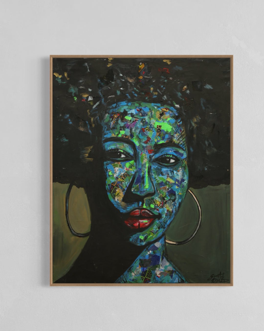 ‘Independent’ by Izuchukwu Giver is a framed, hand-signed mixed media Ankara fabric collage and acrylic painting. It depicts a calm woman with hoop earrings, her blue-green face contrasting her dark hair and background.