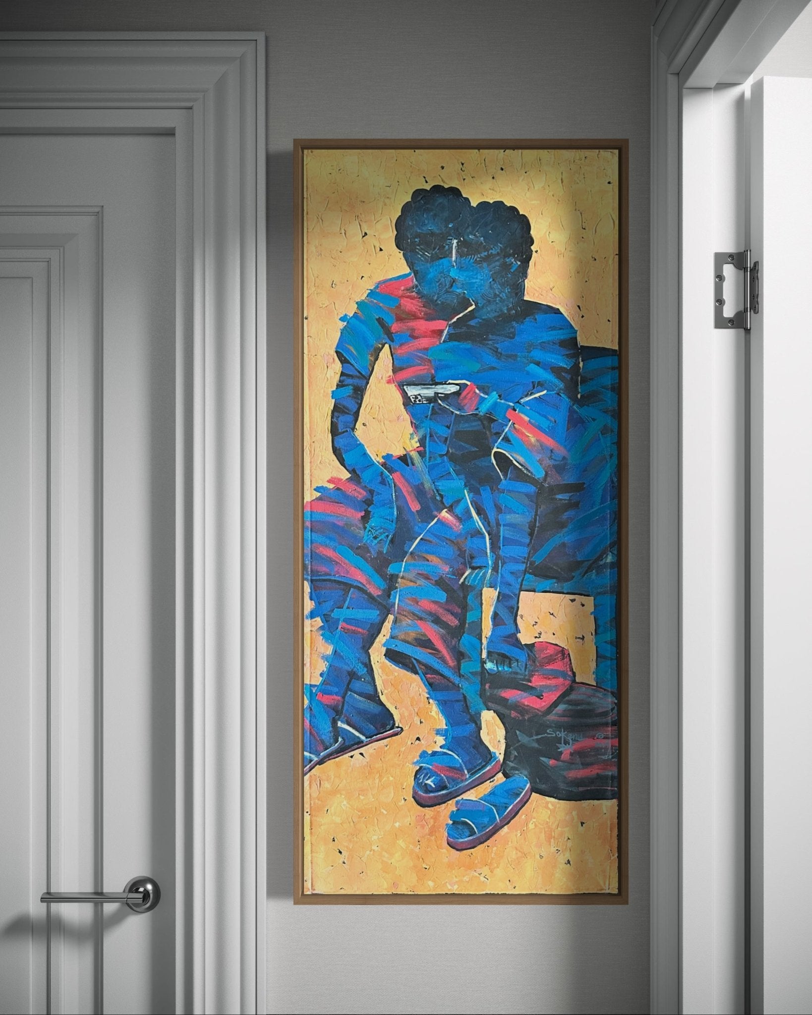 Intervention" by Sokenu Abayomi is a framed abstract painting in a hallway, depicting two faceless figures in blue and red on textured yellow canvas, with a door and handle nearby.