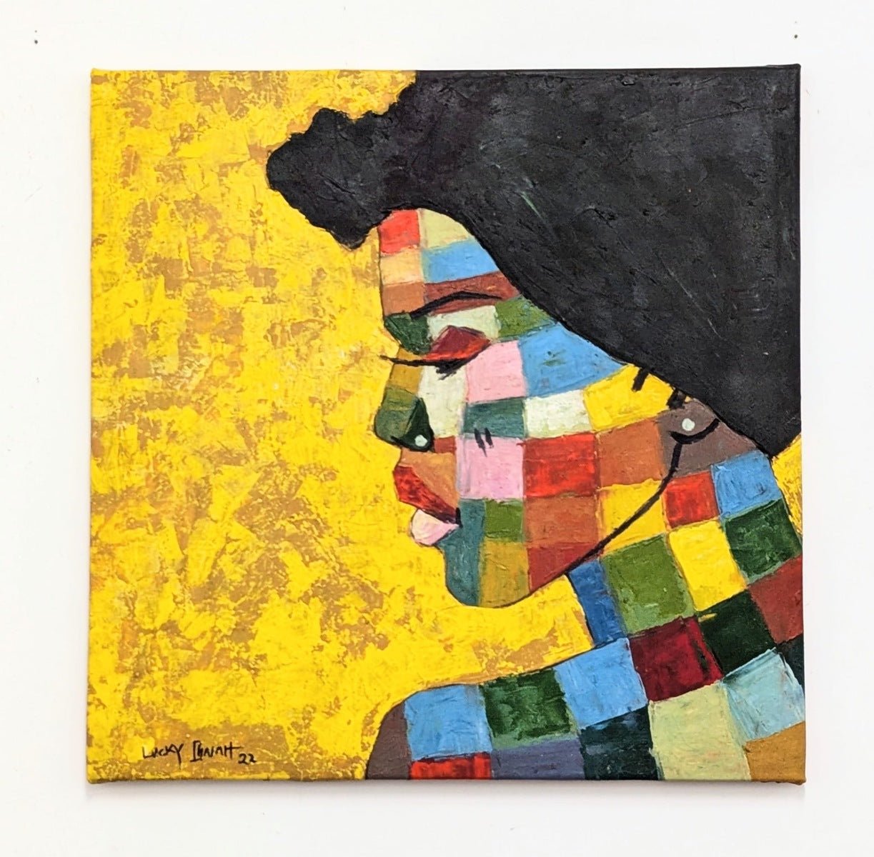 Its My Life" by Lucky Isaiah is a hand-signed painting featuring a person in profile with dark hair, vibrant patchwork squares on their face and neck, set against a textured yellow background. Includes certificate of authenticity.