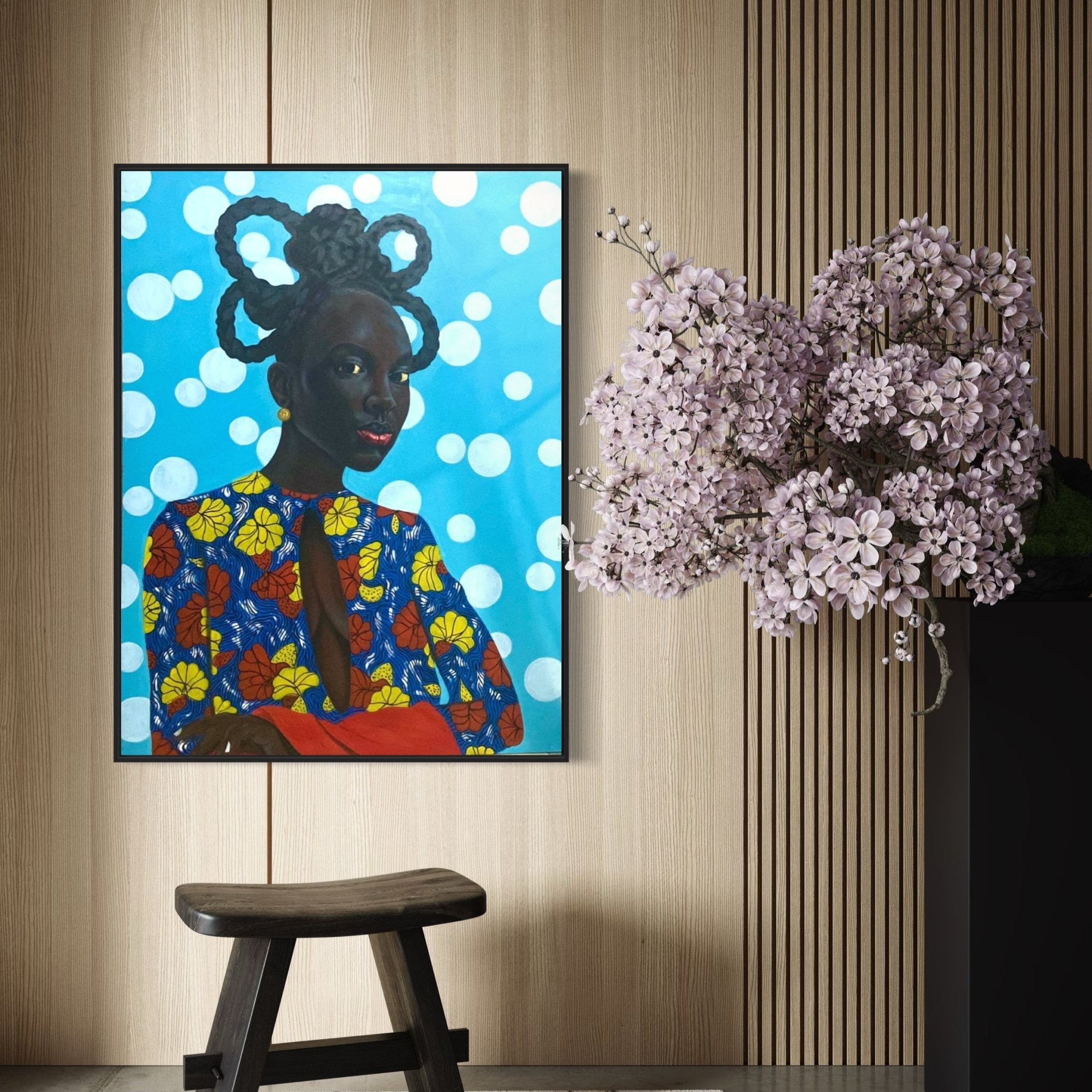 Enigmatic Beauty: 'Lady' by Ajenifuja Abiodun, a framed portrait of an African woman in a vibrant floral outfit inspired by contemporary African art, hangs on a wooden wall beside purple flowers and a simple wooden stool.