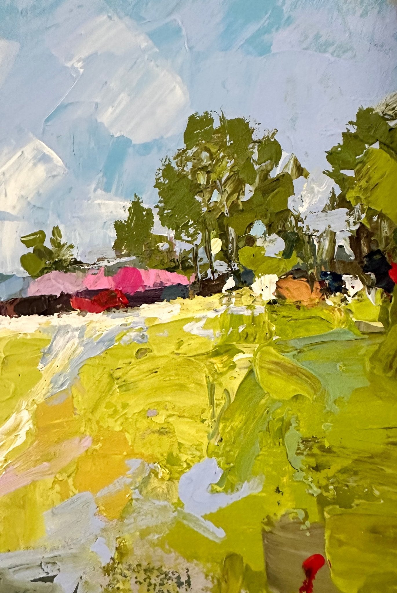 Long Awaited Visit" by Wande George is an impressionistic acrylic on canvas featuring green fields, trees, a blue sky, and pink and red forms, brought to life with bold textured brushstrokes in a contemporary Nigerian style.