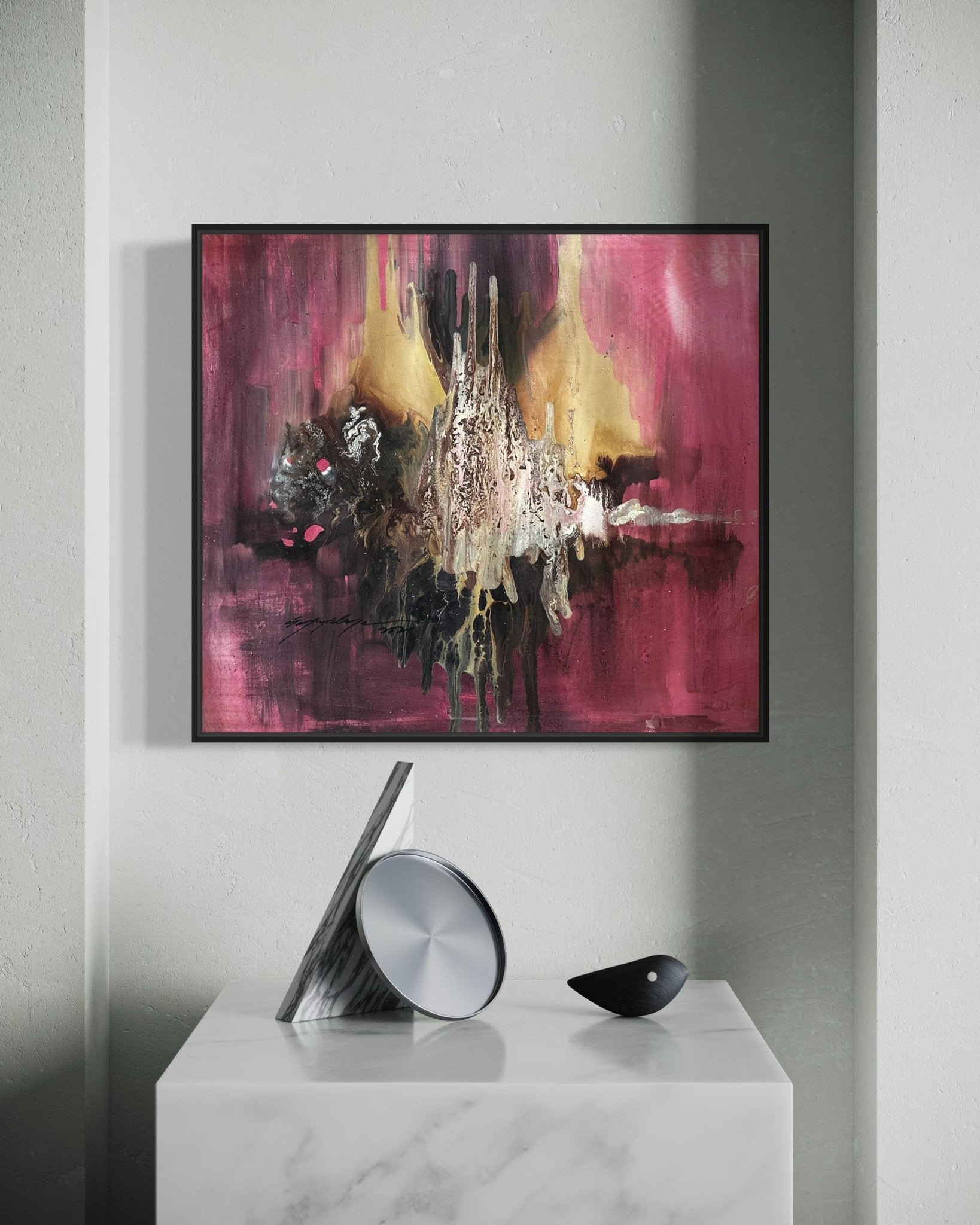 ‘Majority’ by Soji O, an abstract oil painting with gold, black, and beige splashes on red, is displayed on a gray wall above a white marble table featuring a modern gray cone sculpture and a small black piece.