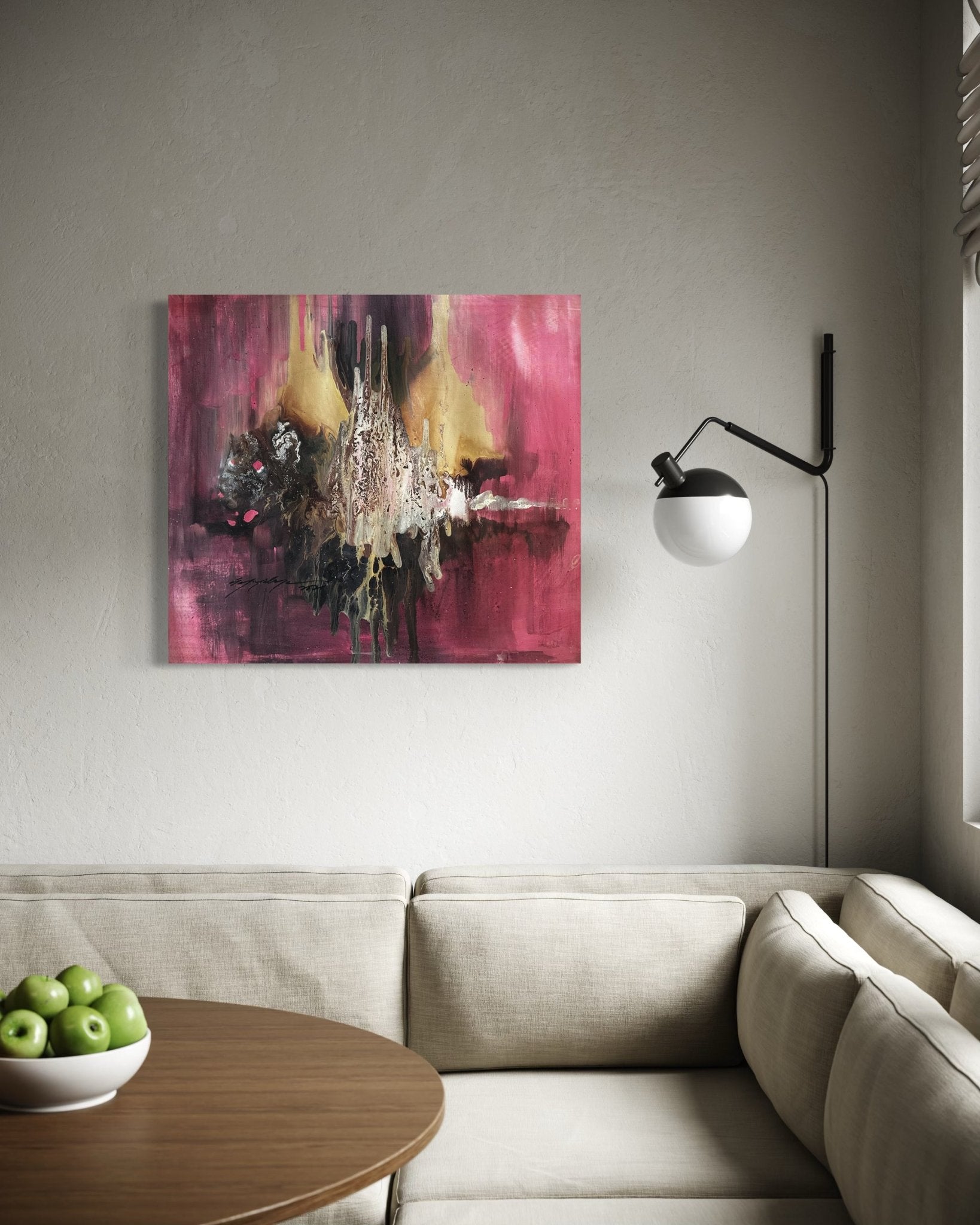 A modern living room with a beige sectional, round wooden table with green apples, black wall lamp, and 'Majority' abstract oil on canvas by Soji O—complete with certificate of authenticity—hanging on a light wall.