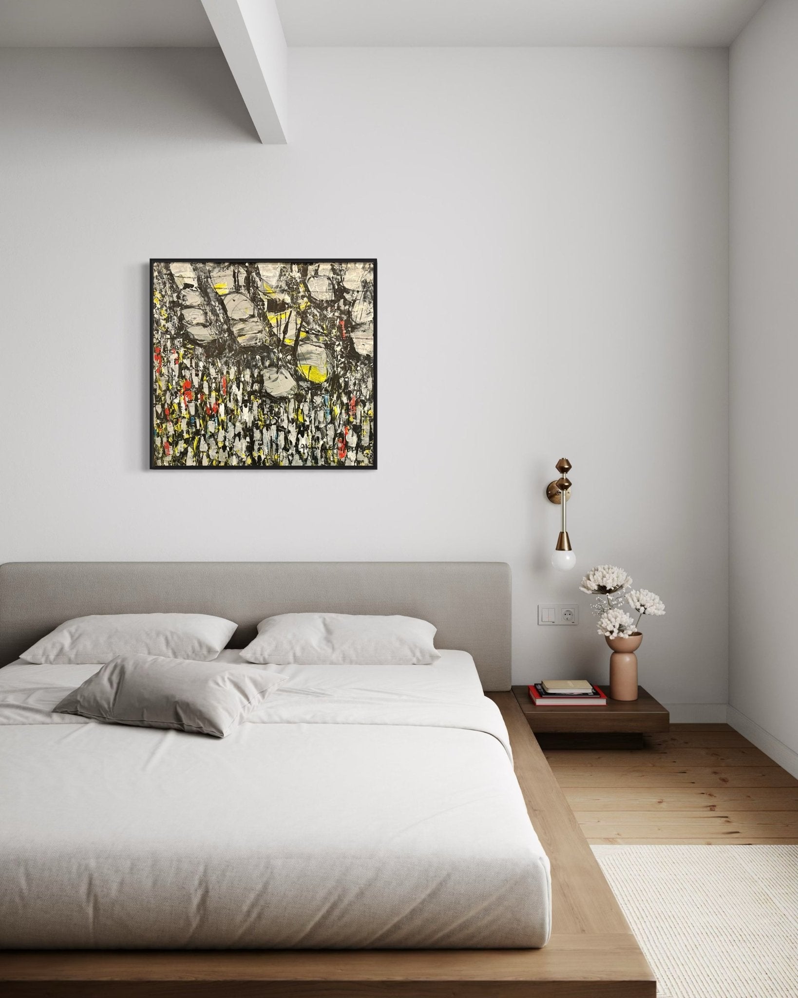 A modern, minimalist bedroom with a low wooden bed, light bedding, and pillows. Above the bed hangs "Making Our Way Home" by Akhile Ehiforia, depicting a Nigerian street market at rush hour; white walls complete the calm look.
