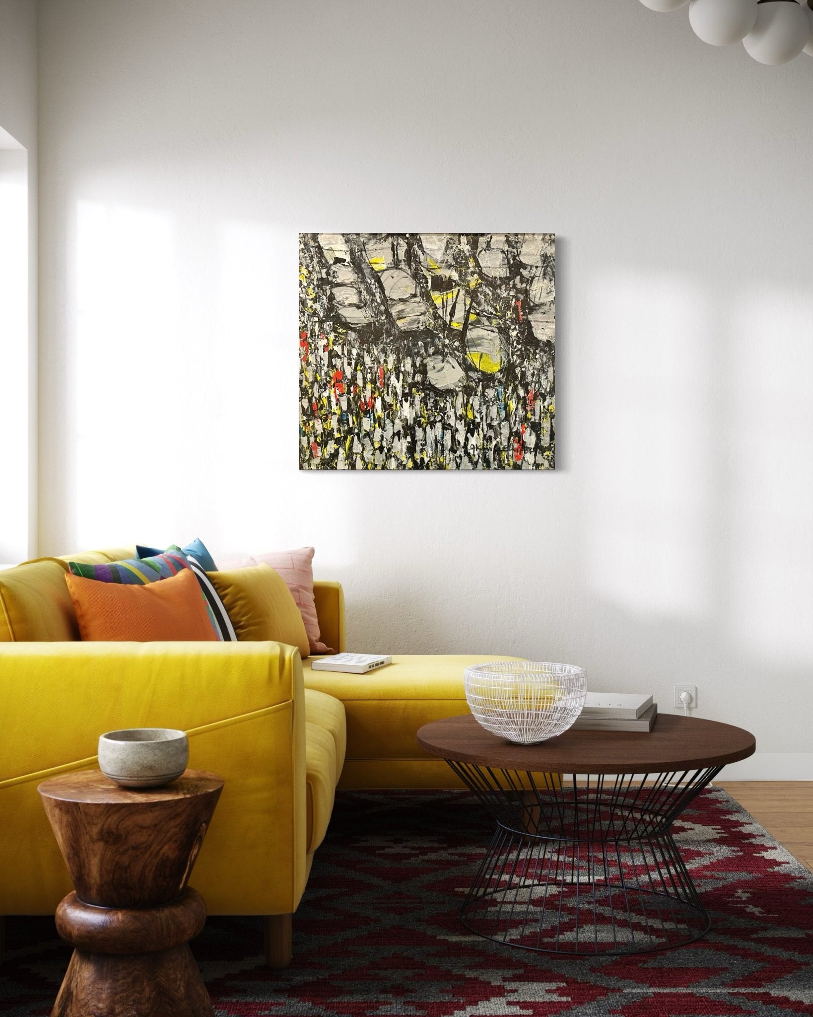 A modern living room with a bright yellow couch, colorful cushions, and "Making Our Way Home"—an original Akhile Ehiforia painting of a Nigerian street market—hangs above. A red patterned rug and round wooden coffee table complete the sunlit space.