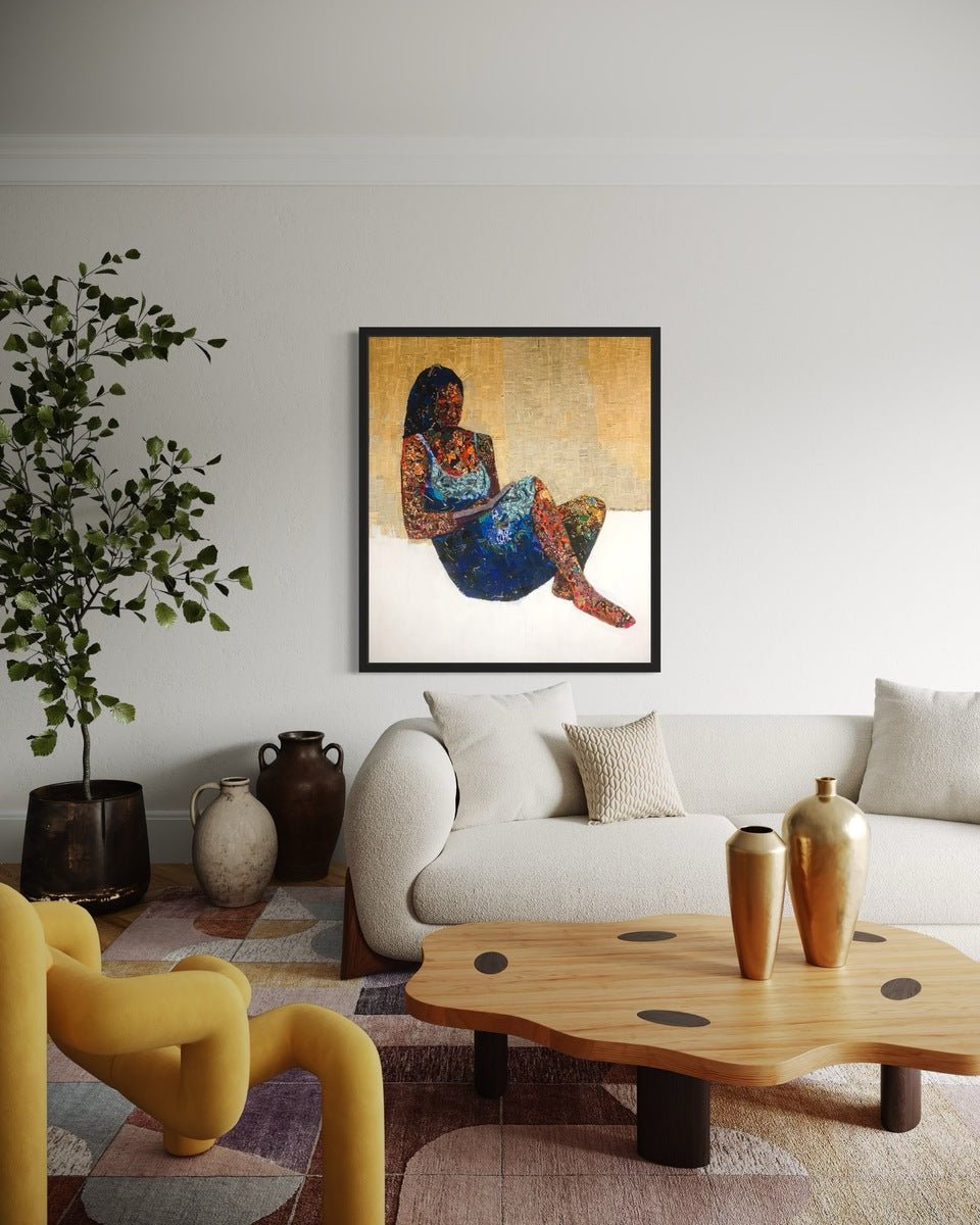 A modern living room featuring a light sofa, gold vases on a wooden coffee table, a yellow chair, and "Love Book," a mixed media painting of a woman by Seye Morakinyo above the sofa.