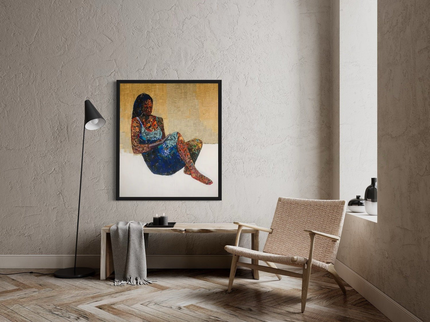 A modern, minimalist room with beige walls features a woven chair, Seye Morakinyo's "Love Book" mixed media painting of a woman amid pages of writing on the wall.
