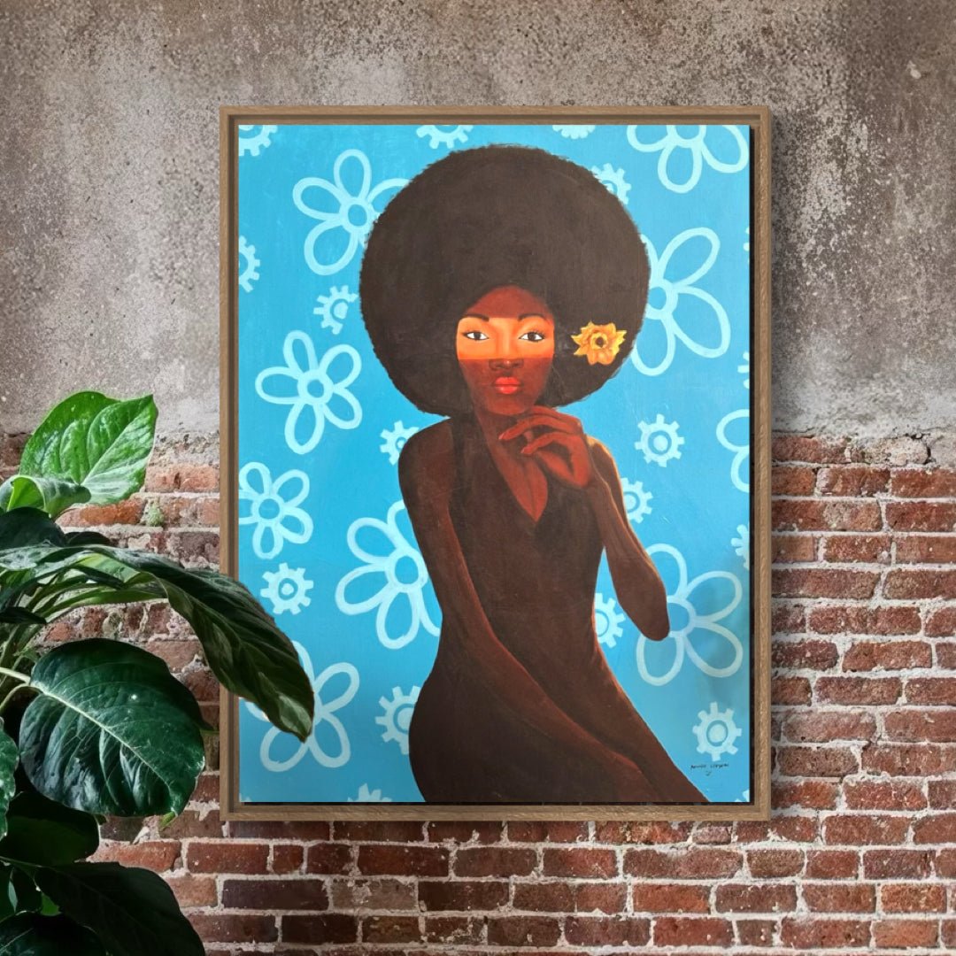 My Afro 2" by Afuope Opeyemi, a framed acrylic on canvas showing a dark-skinned woman with a large afro and yellow flower, set against blue with white flowers, hangs on a brick wall beside a green plant.