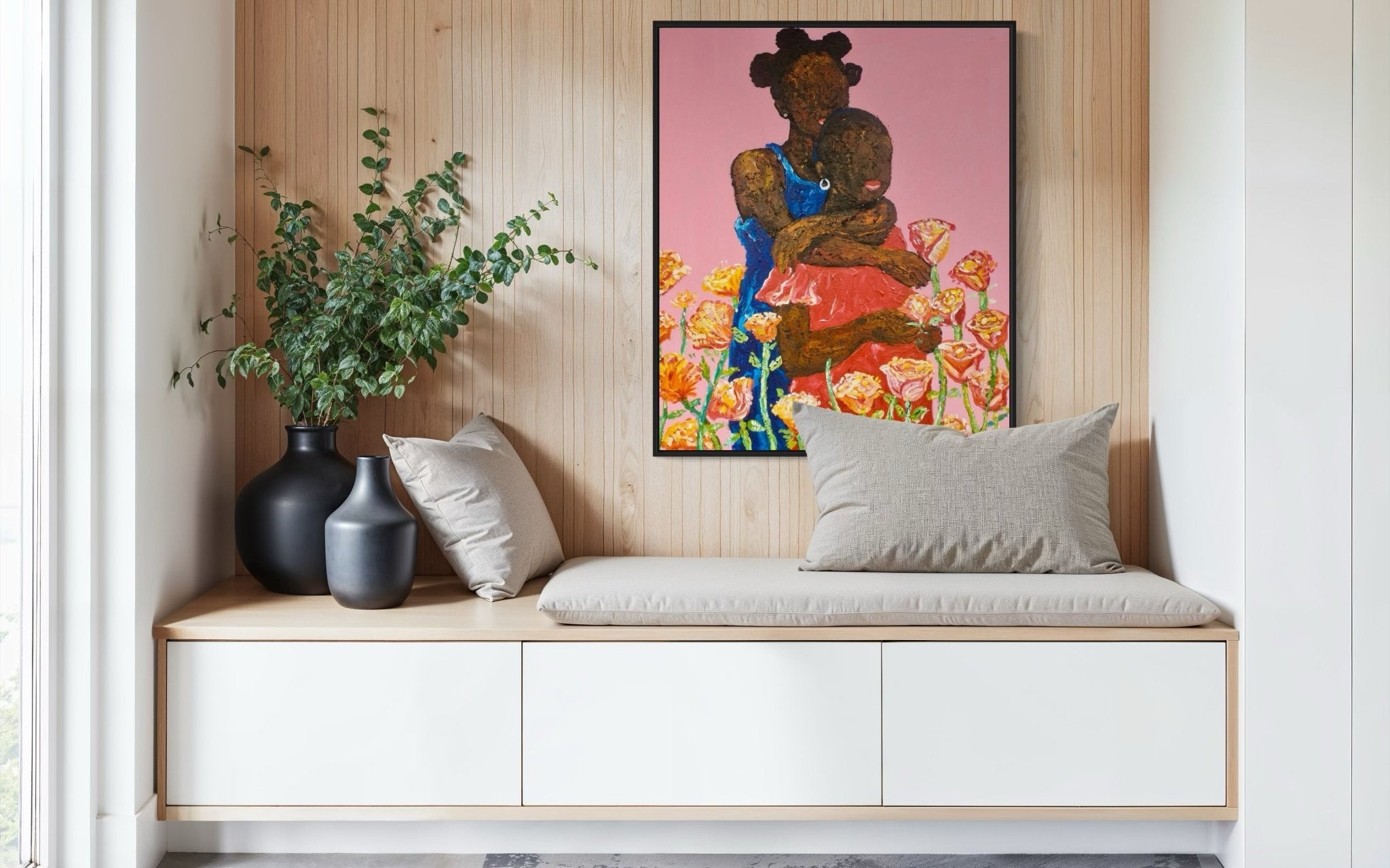 A cozy bench with a beige cushion and pillows sits by a wood-paneled wall, adorned with black vases holding greenery. Above it hangs "Companion. Acrylic on Canvas" by Ola Kuti, featuring a vibrant woman with flowers.