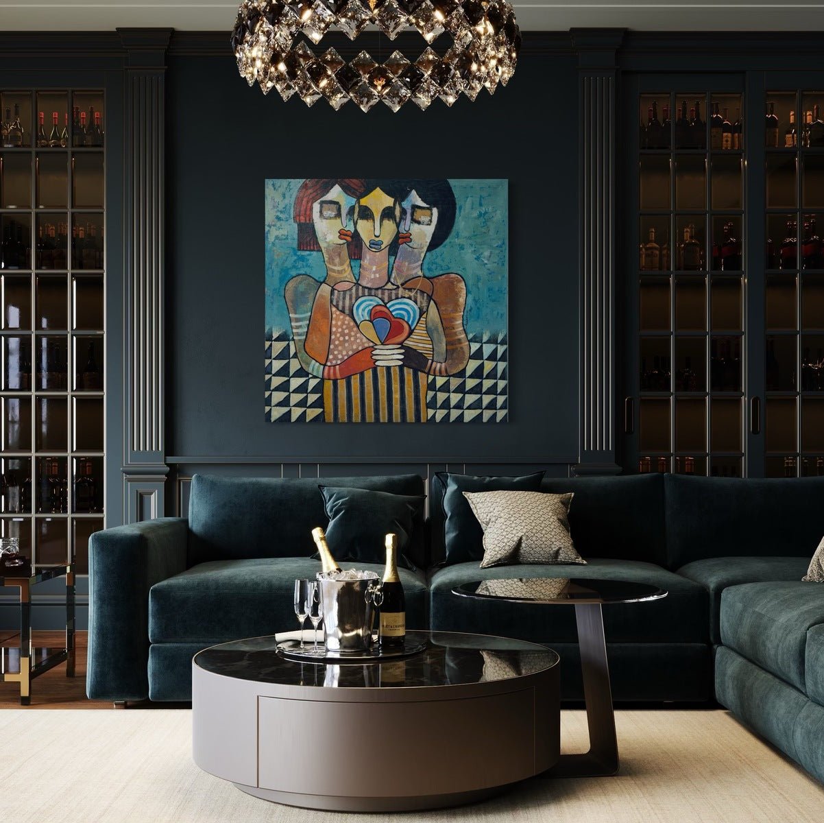 A modern living room with a dark green velvet sectional, circular coffee table with champagne bottles, a geometric chandelier, and "One Love"—a colorful hand-signed acrylic on canvas by Achike Anayo—hanging on the wall.