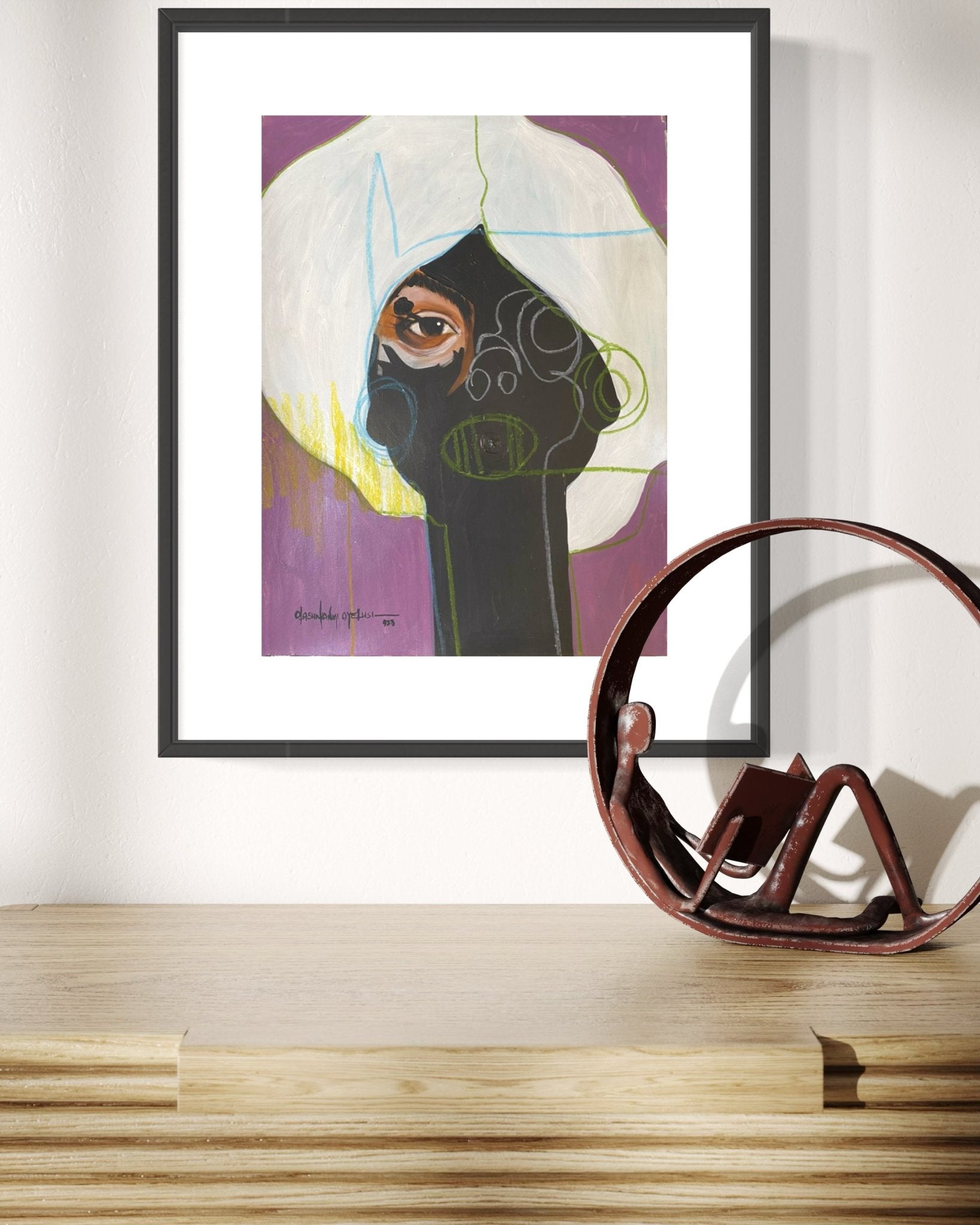 Eye Of Hope" Abstract Portrait On Card by Olasunkanmi Oyelusi hangs on a white wall above a light wood table. The bold acrylic painting features contrasting colors; a brown abstract sculpture rests below the artwork.