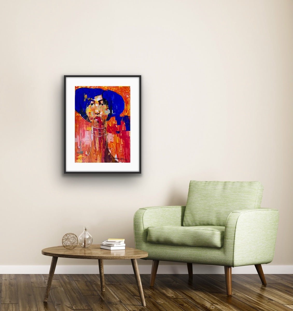 A modern living room with a light green armchair, a round wooden coffee table, and Olasunkanmi Oyelusi’s "One of a Kind Series" painting—bold red, orange, and blue acrylic on paper—hanging above the chair.