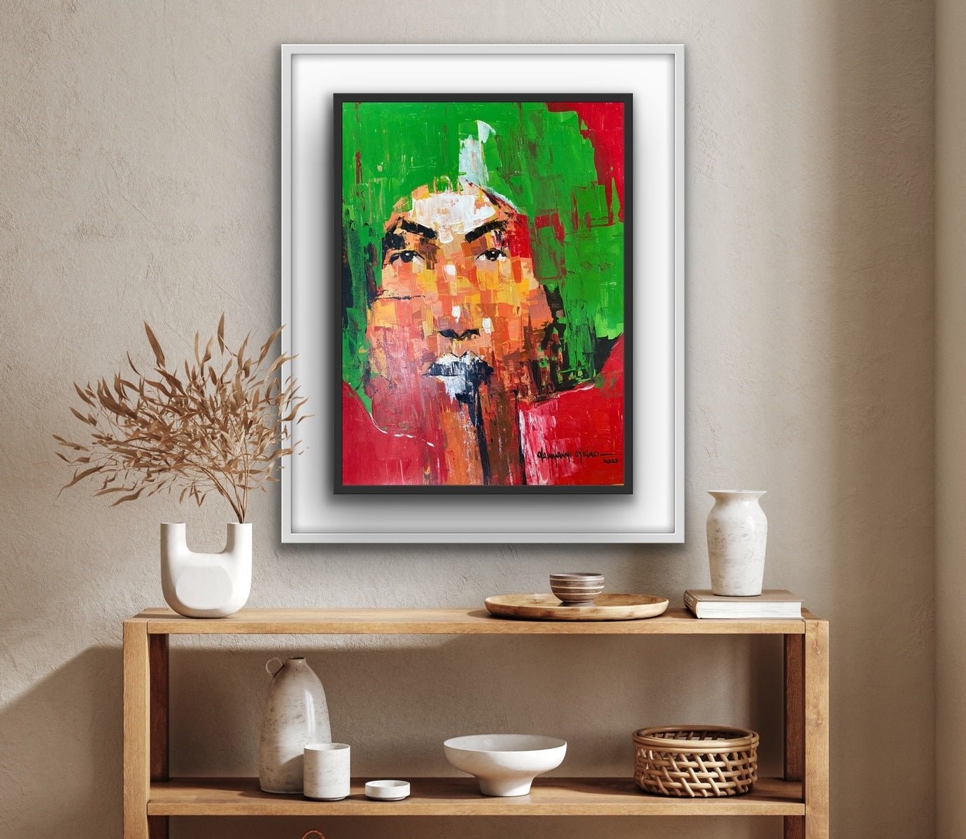 The "One of a Kind Series by Oyelusi" original painting by Olasunkanmi Oyelusi features bold green, red, and orange acrylic strokes in a white frame above a wooden shelf with neutral vases, bowls, and dried foliage.