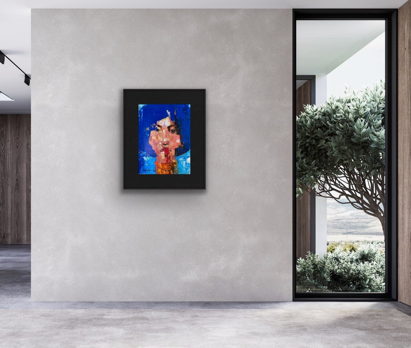 A unique acrylic abstract painting from the One of a Kind Series by Olasunkanmi Oyelusi features a human face in blue, red, and pink hues displayed on a gray wall in a modern room with large windows overlooking trees and landscape.
