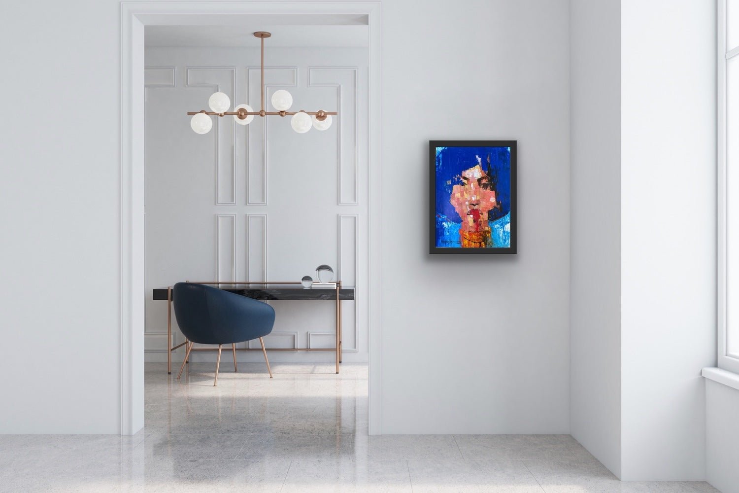 A modern, minimalist room with a sleek desk and blue chair displays an original "One of a Kind Series by Oyelusi" abstract portrait (Olasunkanmi Oyelusi) on the wall, a contemporary chandelier above, and sunlight streaming through a large window.