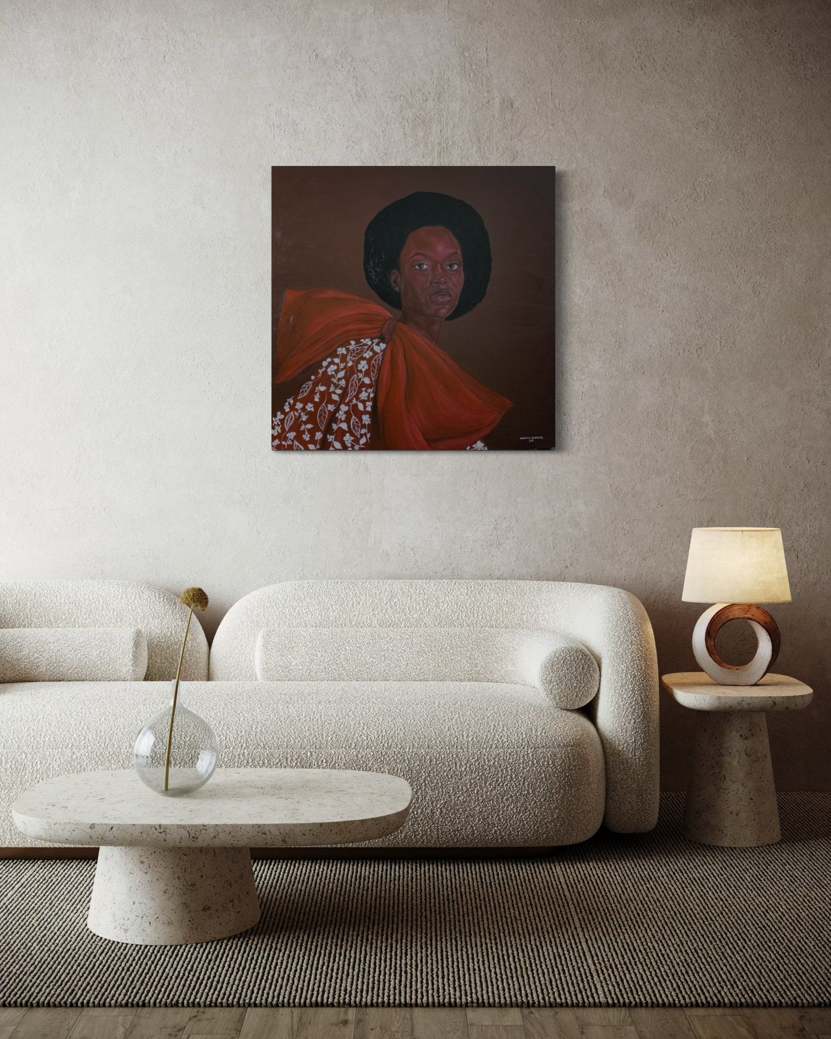 A minimalist living room features a textured beige sofa, coffee table, and lamp. Above hangs "Portrait by Hammed Omobayo" from Hammed Olayanju Omobayo, a hand-signed artwork in orange with certificate of authenticity for collectors.