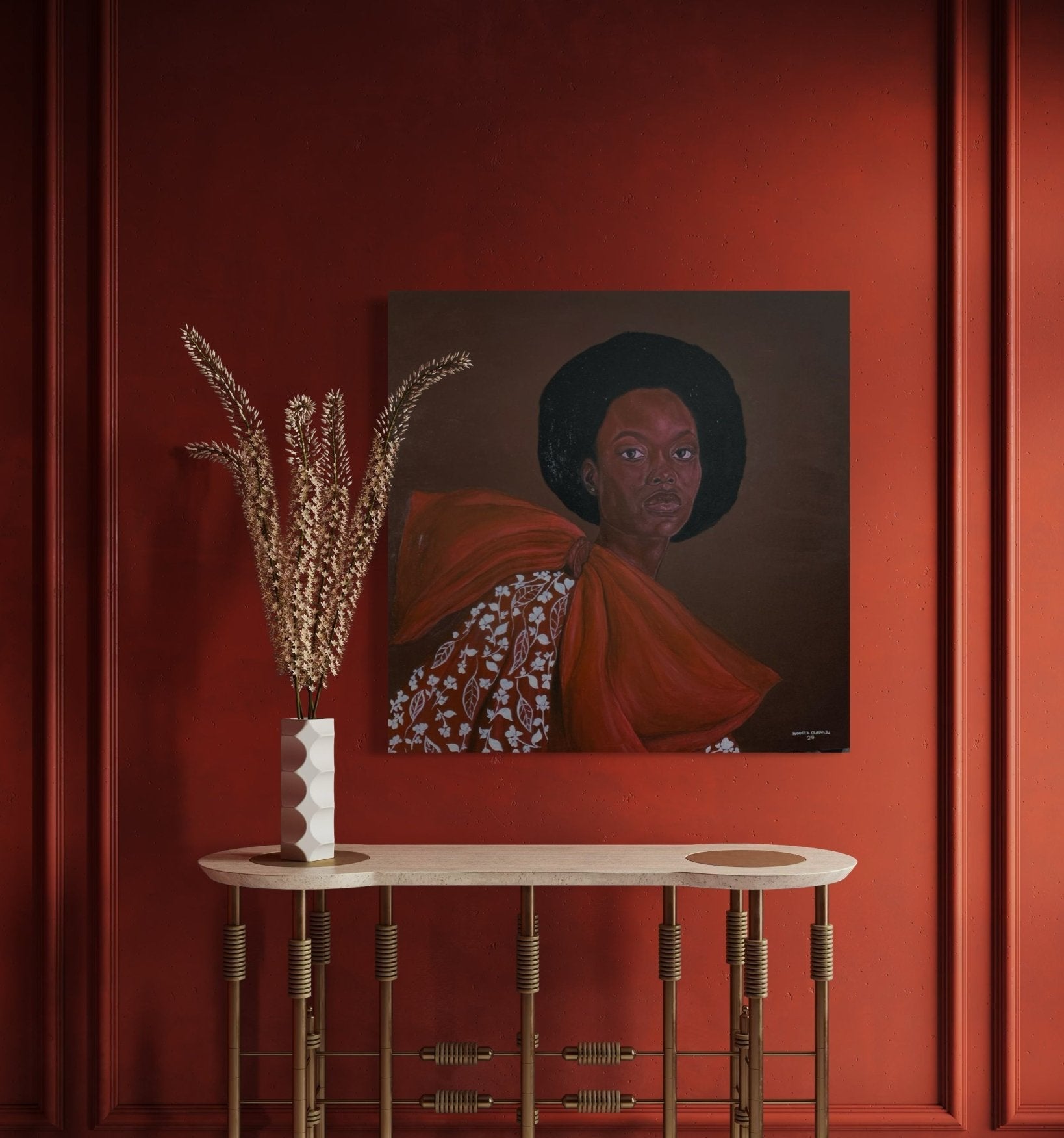 A modern console table with a vase of dried grass stands against a red wall, topped by "Portrait by Hammed Omobayo"—a hand-signed painting from Hammed Olayanju Omobayo, depicting a woman in patterns and bow, with certificate of authenticity.