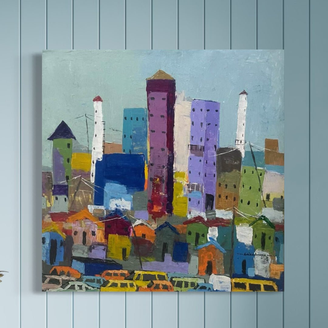 Somewhere In Lagos City" by Achike Anayo features a vibrant cityscape with tall, blocky blue, purple, and pink buildings, smaller houses, and yellow cars. Displayed on a light blue paneled wall; comes with a certificate of authenticity.