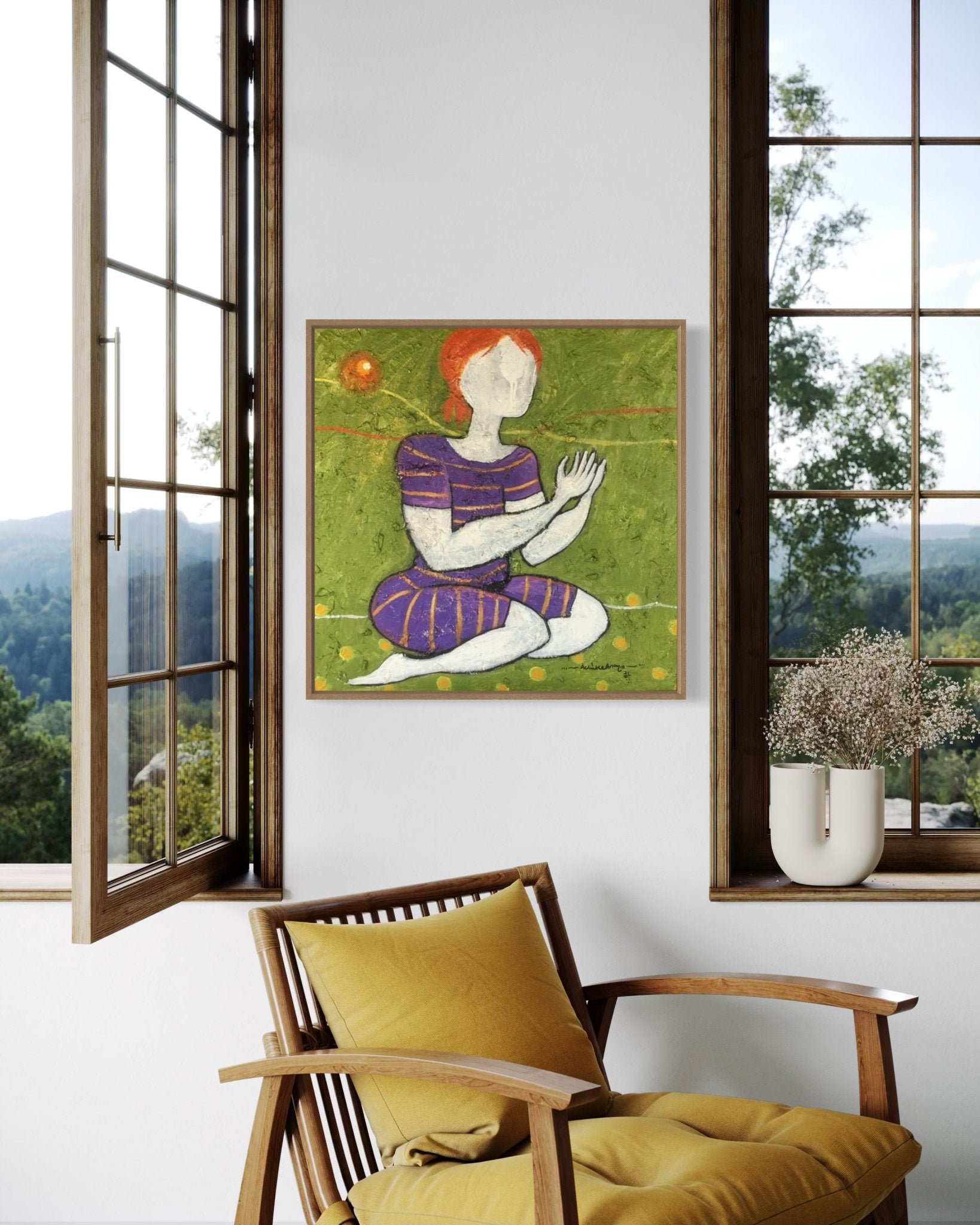 A cozy corner with a yellow cushion chair and vase of flowers beneath a window. On the wall hangs "Suplication 4" by Achike Anayo—an acrylic on canvas of a faceless figure kneeling on grass with green and orange tones.