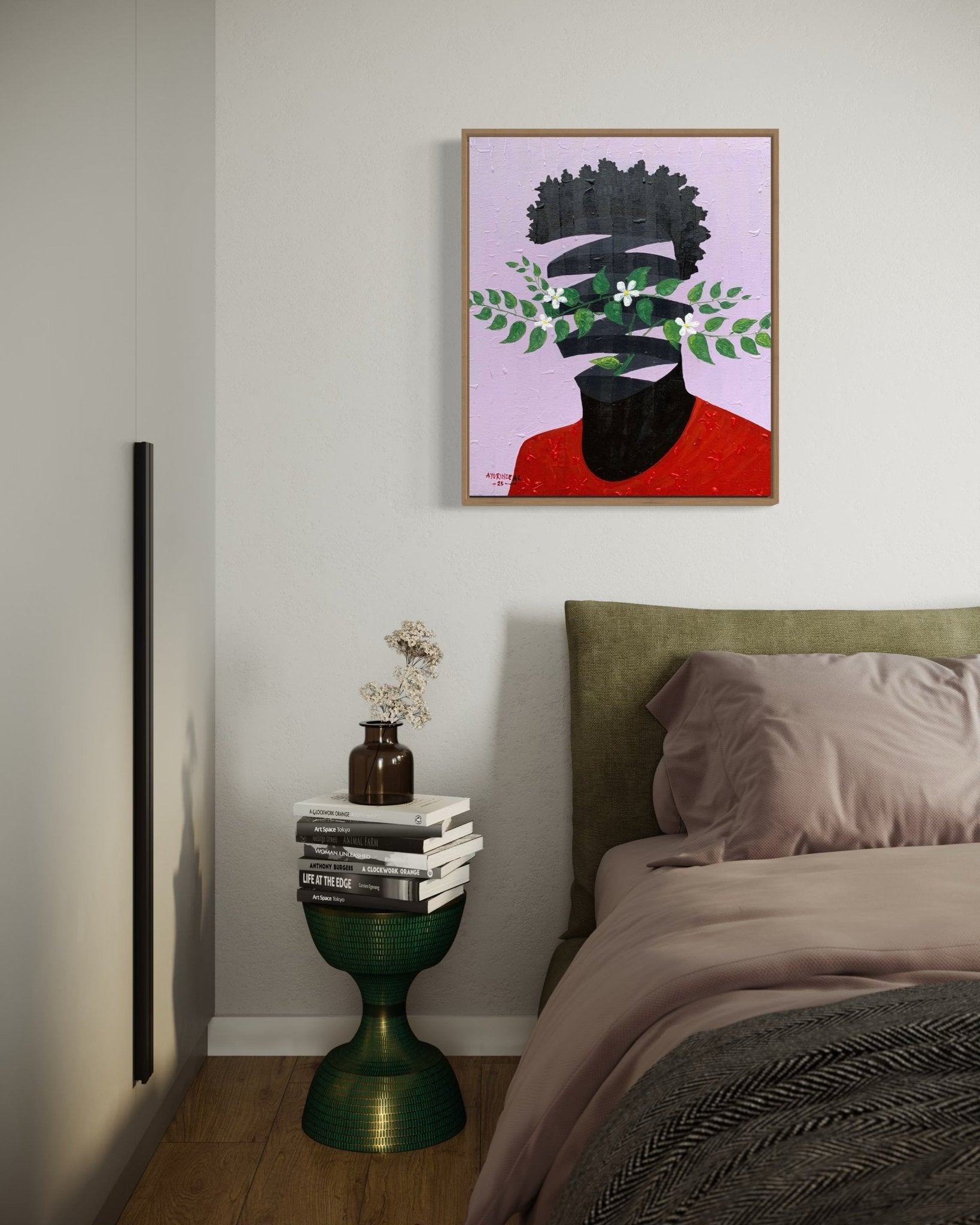 A cozy bedroom corner features a green side table with books and flowers, next to an olive green bed. Above the table hangs "Surrealist Portrait painting by Ayorinde" from Ayorinde Ayobami Lekan, depicting a face with leaves and flowers.