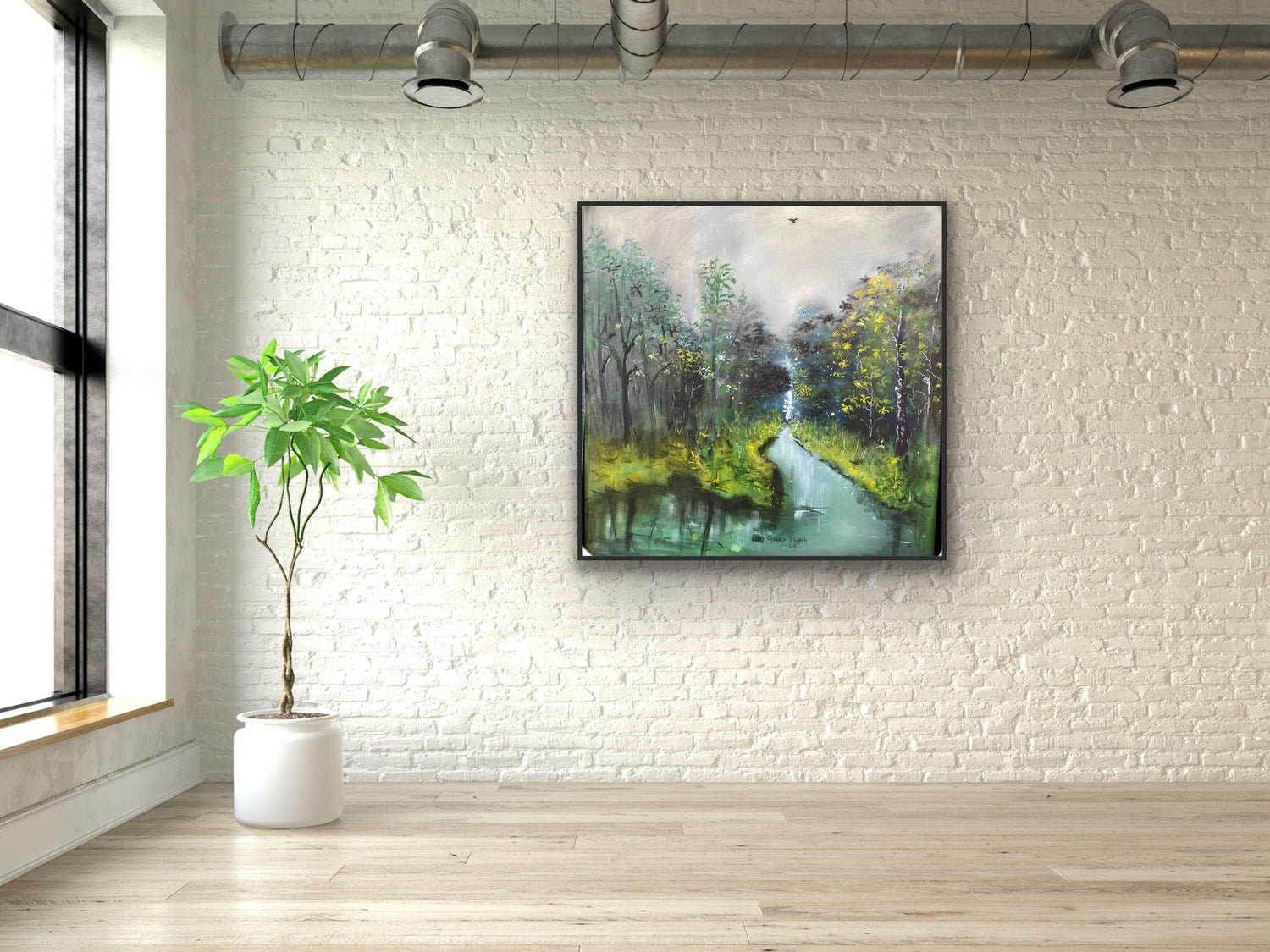 A minimalist room with a white brick wall, light wood floor, and a potted plant features "The Great Outdoors," a large hand-signed acrylic on canvas by Oyebisi Elijah depicting a serene forest and river scene.