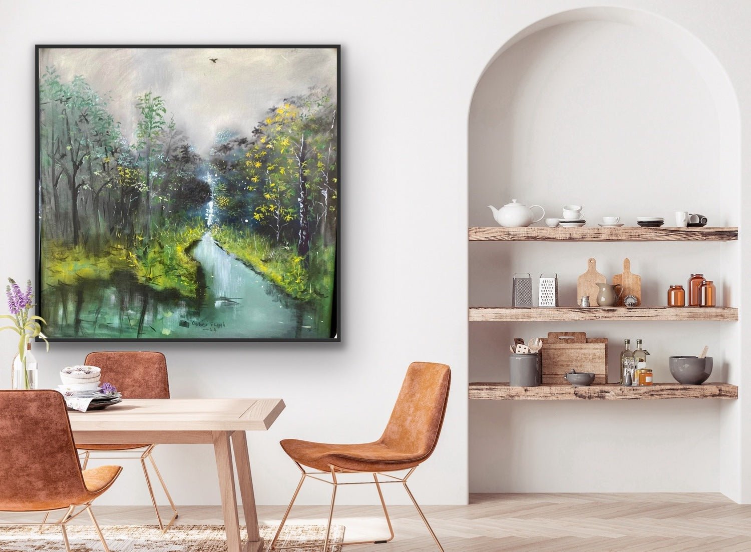A dining area features a wooden table, brown chairs, and "The Great Outdoors" by Oyebisi Elijah—a large hand-signed acrylic on canvas of a forest stream—while shelves with pottery and kitchenware add to the cozy, modern vibe.