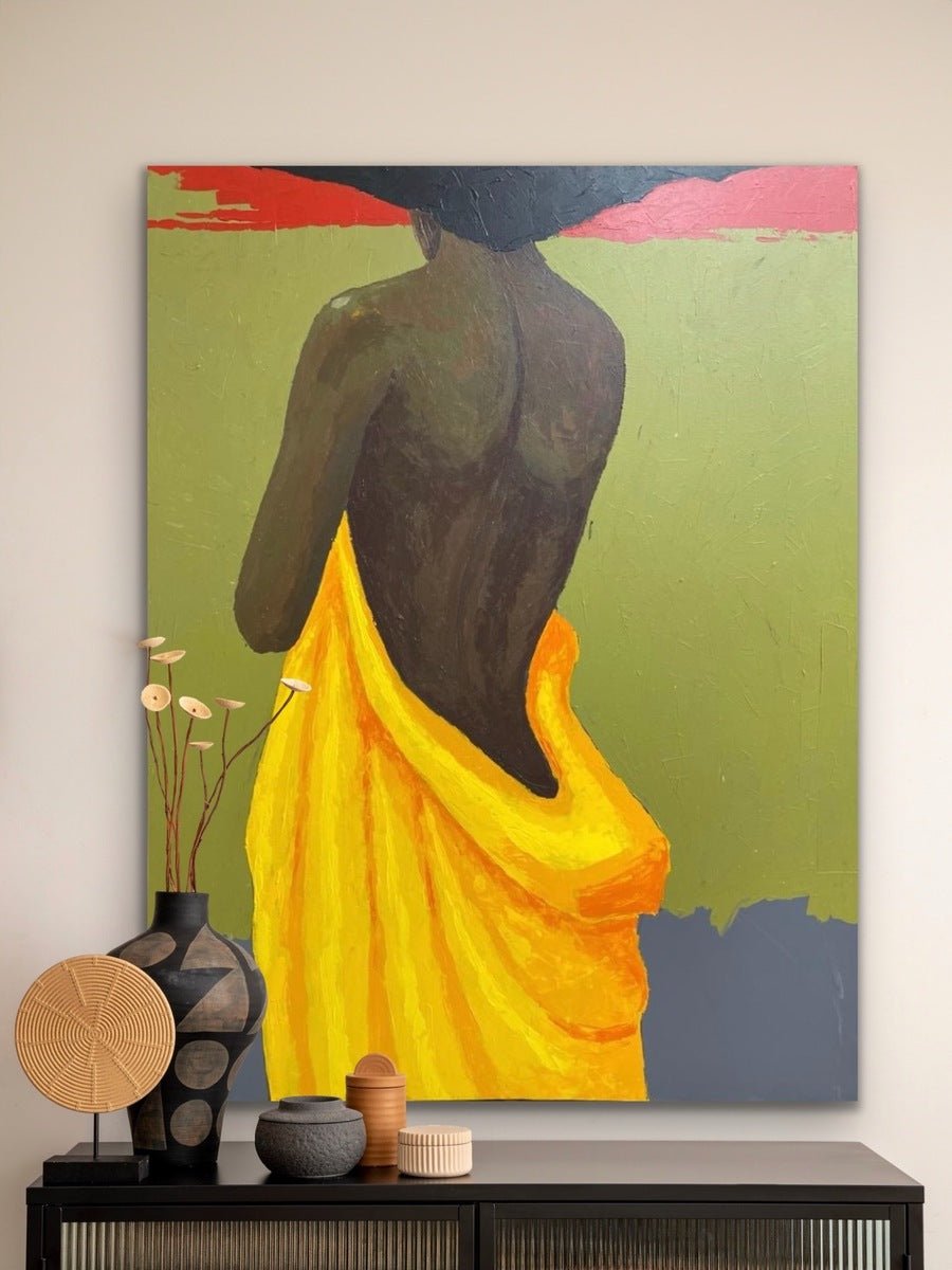 The Yellow Fabric" by Faith O Sidneu, a large, hand-signed acrylic on canvas, depicts a dark-skinned figure draped in yellow cloth before lush green and red tones—perfect to display above cabinets with vases, dried flowers, or woven baskets.