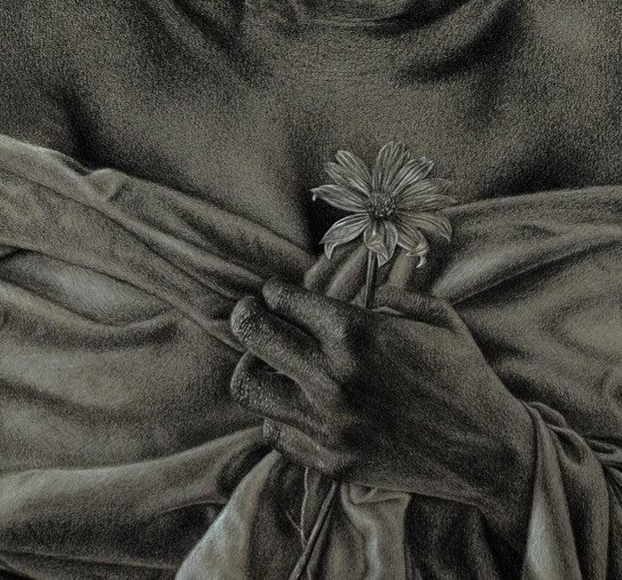 A grayscale image in contemporary realism from Emmanuel Ugwu’s "Trauma" shows a hand holding a daisy to the chest, wrapped in soft fabric revealing collarbone and shoulders.