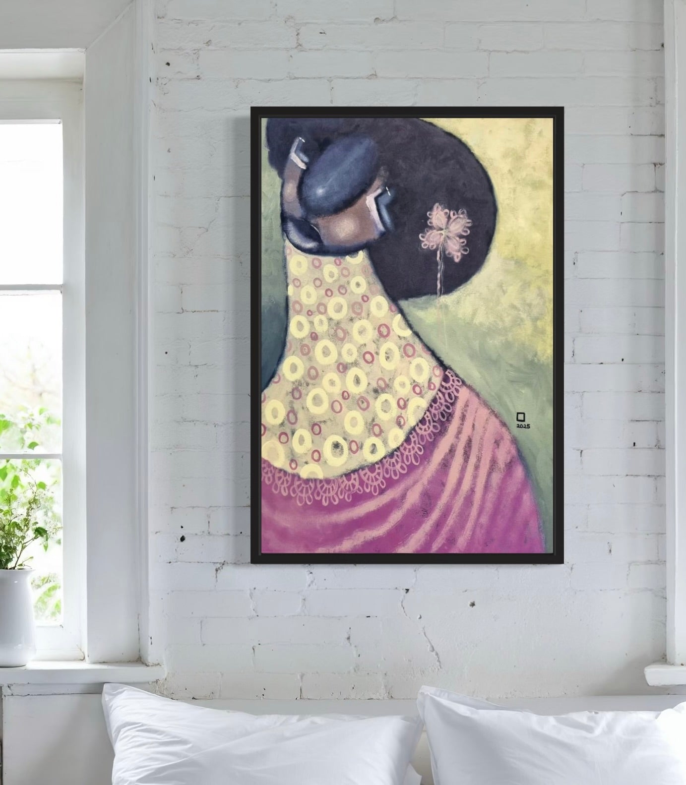 The "Untitled" Portrait Painting by Prince Obasi, featuring a woman in a hat and colorful dress, is displayed above a bed with pillows on a white brick wall near a bright window with green plants.