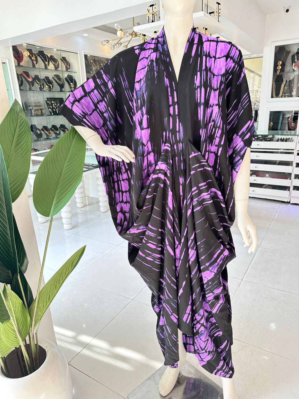A mannequin features our best seller, the Zoya Drapped Dress by bibianna.co.uk—a stunning midi dress ideal for any occasion.